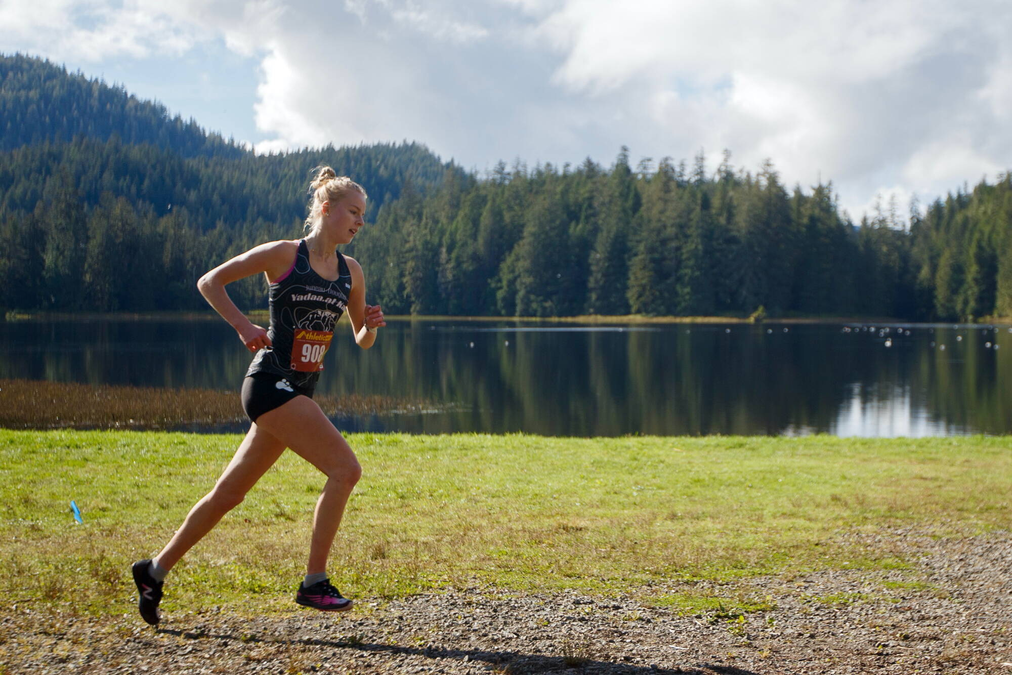 Juneau-Douglas High School: Yadaa.at Kalé’s Ida Meyer runs past Ward Lake as she competes in the Women’s 5,000-meter race during the Division 1 Region V Cross Country event on Saturday, Sept. 28, 2024. Meyer won the event with a time of 19:37.76. (Christopher Mullen/ Ketchikan Daily News)