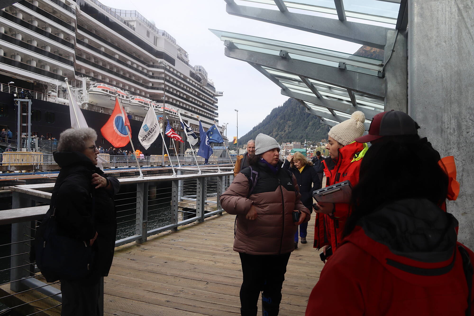 Cruise ship passengers and shore excursion providers talk on the South Franklin Cruise Dock at midday Monday after the Koningsdam arrives in port. (Mark Sabbatini / Juneau Empire)