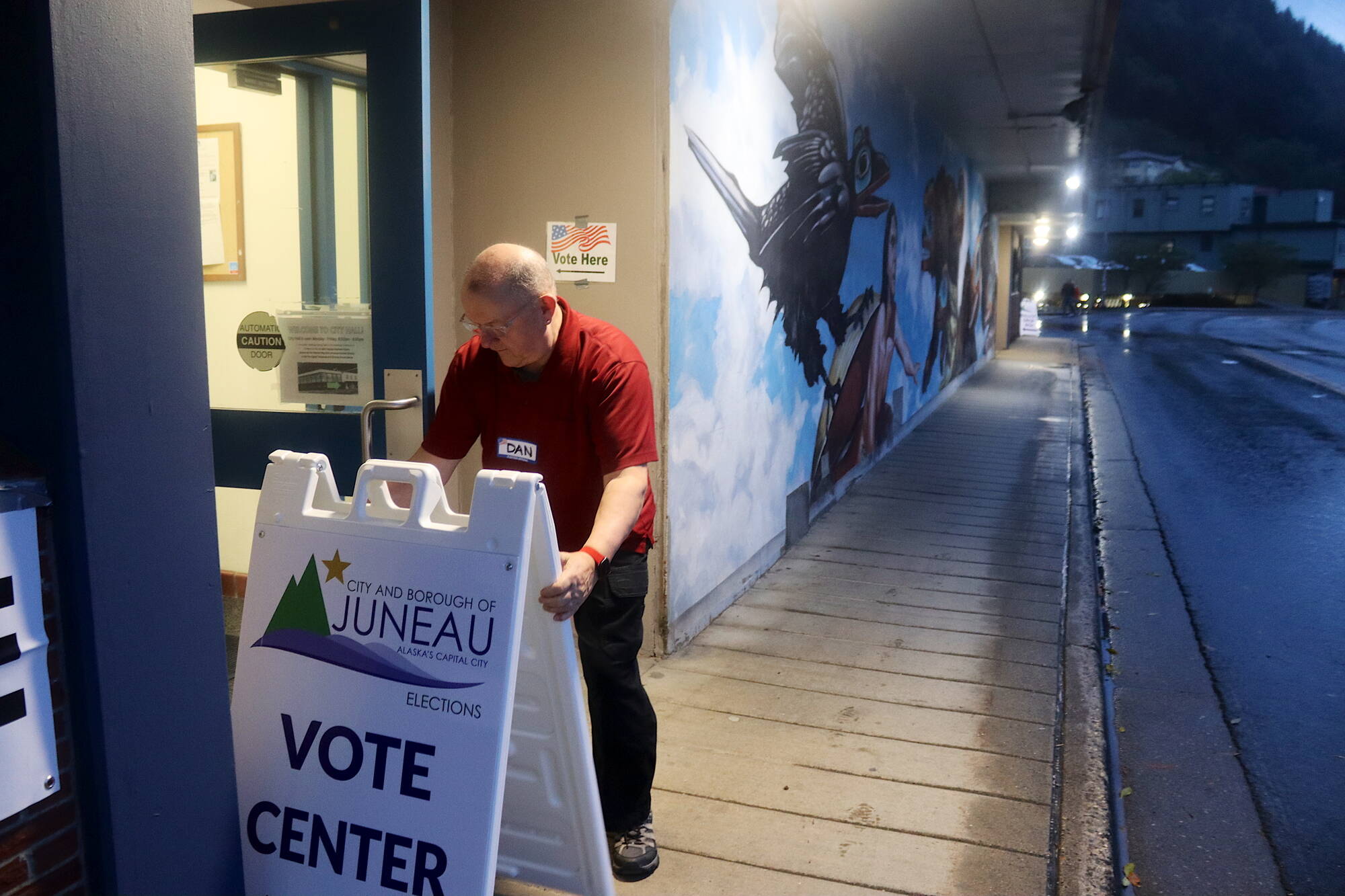 Dan Kenkel sets up an election sign outside City Hall as in-person voting begins at 7 a.m. Tuesday in Juneau’s municipal election. Voting locations and ballot dropoff boxes are open until 8 p.m. tonight.