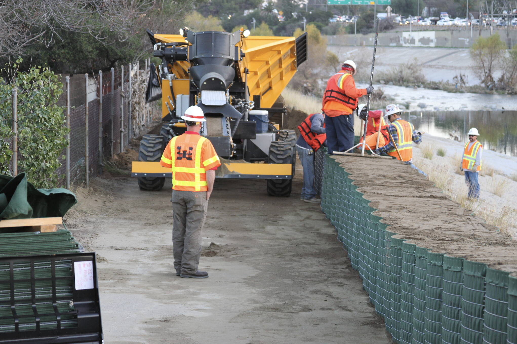 Workers install Hesco Barriers along the Los Angeles River to protect against El Niño flooding in 2016. Similar barriers along the Mendenhall River are being considered by Juneau city leaders. (U.S. Army Corps of Engineers photo)