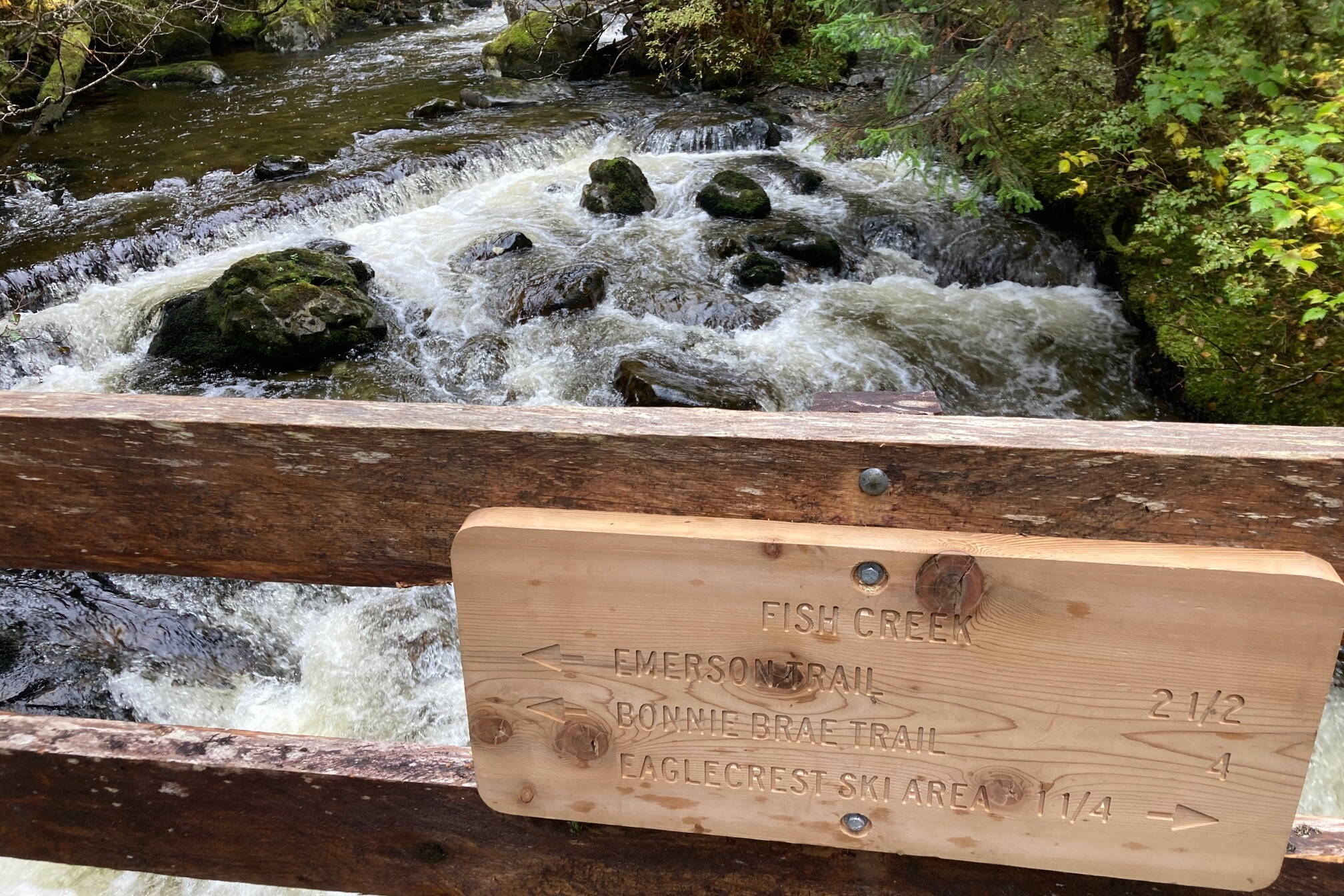 A newly installed Forest Service sign orients recreators on the reconstructed Fish Creek bridge, one of 64 bridges that were rebuilt along the 14-mile trail. (Photo by Dave Haas)