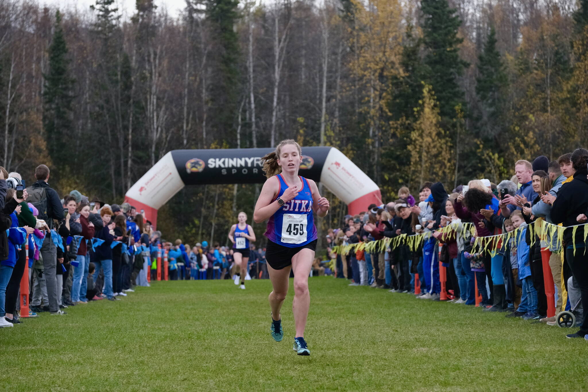 Sitka senior Clare Mullin defends her Division II state championship as she approaches the finish of the 2024 ASAA cross-country running state championships Saturday on the Bartlett High School Trails in Anchorage. (Klas Stolpe / Juneau Empire)