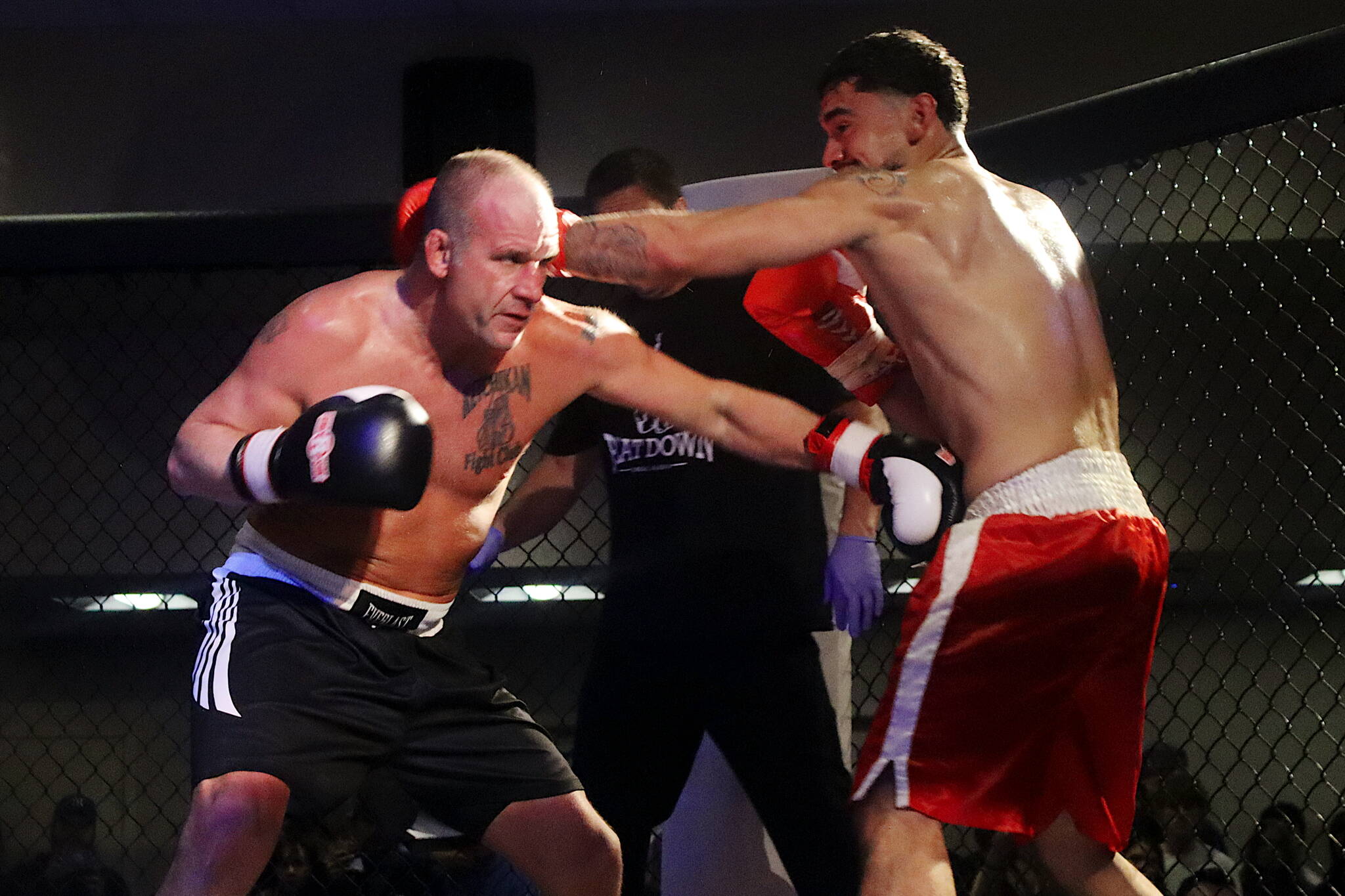 Tyson Duckworth (left) and Marco Reina face off in the main event at AK Beatdown 36 on Saturday night at Elizabeth Peratrovich Hall. (Mark Sabbatini / Juneau Empire)