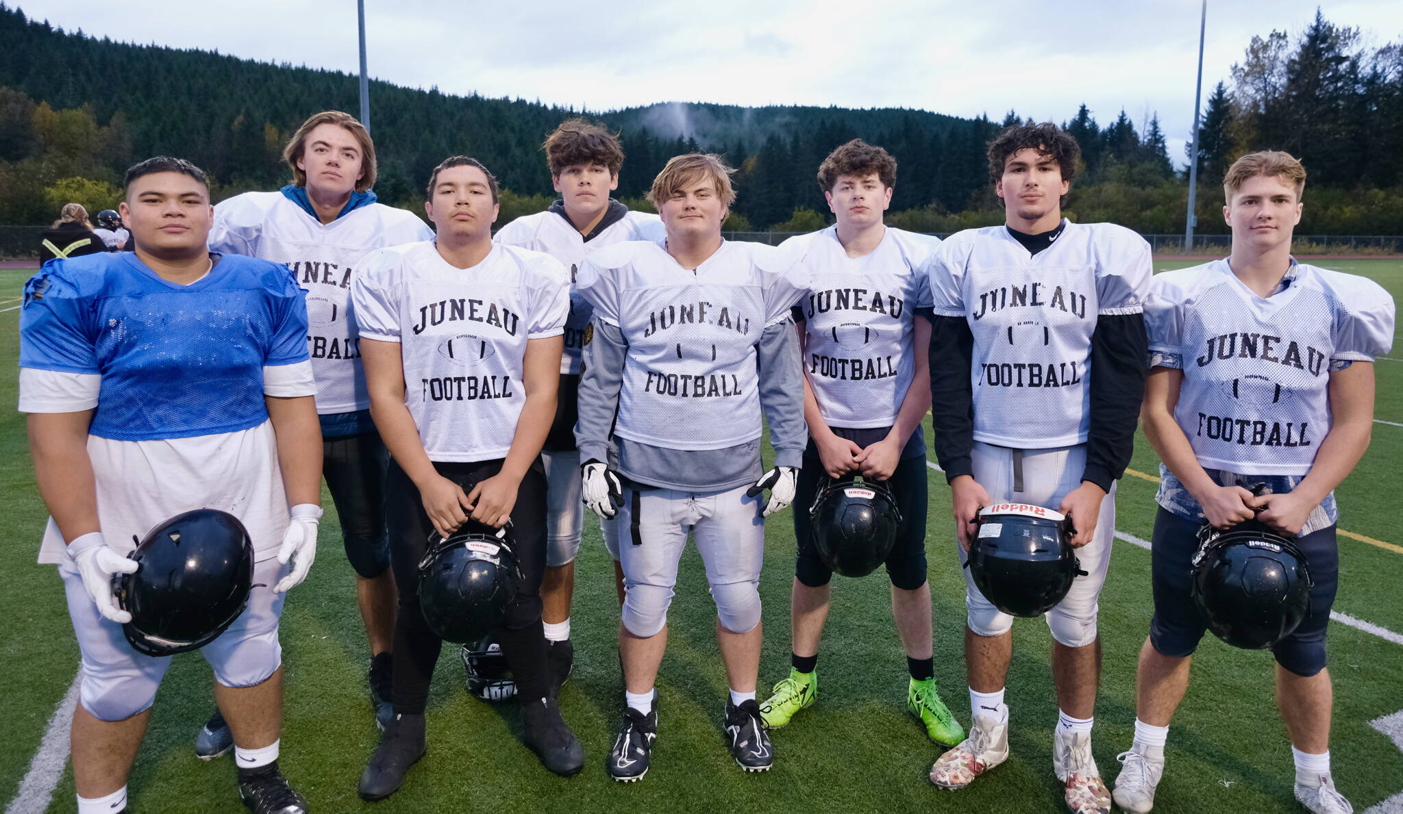 Juneau Huskies linemen (left-to-right) senior Ricky Tupou, senior Gunnar Tarver, junior Walter Haube-Law, junior Jonah Mahle, junior Kyle Carter, senior Merrick Hartman, senior Stefano Rivera and junior Hyrum Fish. (Klas Stolpe / Juneau Empire)