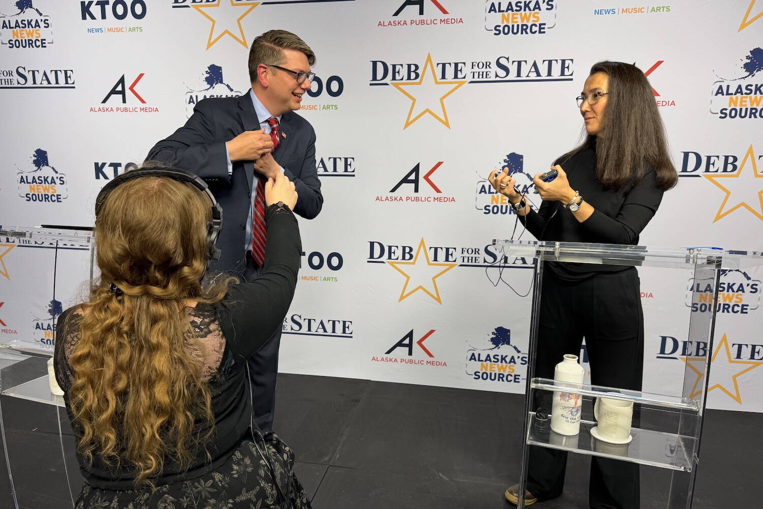 Republican U.S. House candidate Nick Begich, left, and Rep. Mary Peltola, D-Alaska (right) remove their microphones after a televised debate Thursday night, Oct. 10, 2024, in Anchorage. (James Brooks/Alaska Beacon)