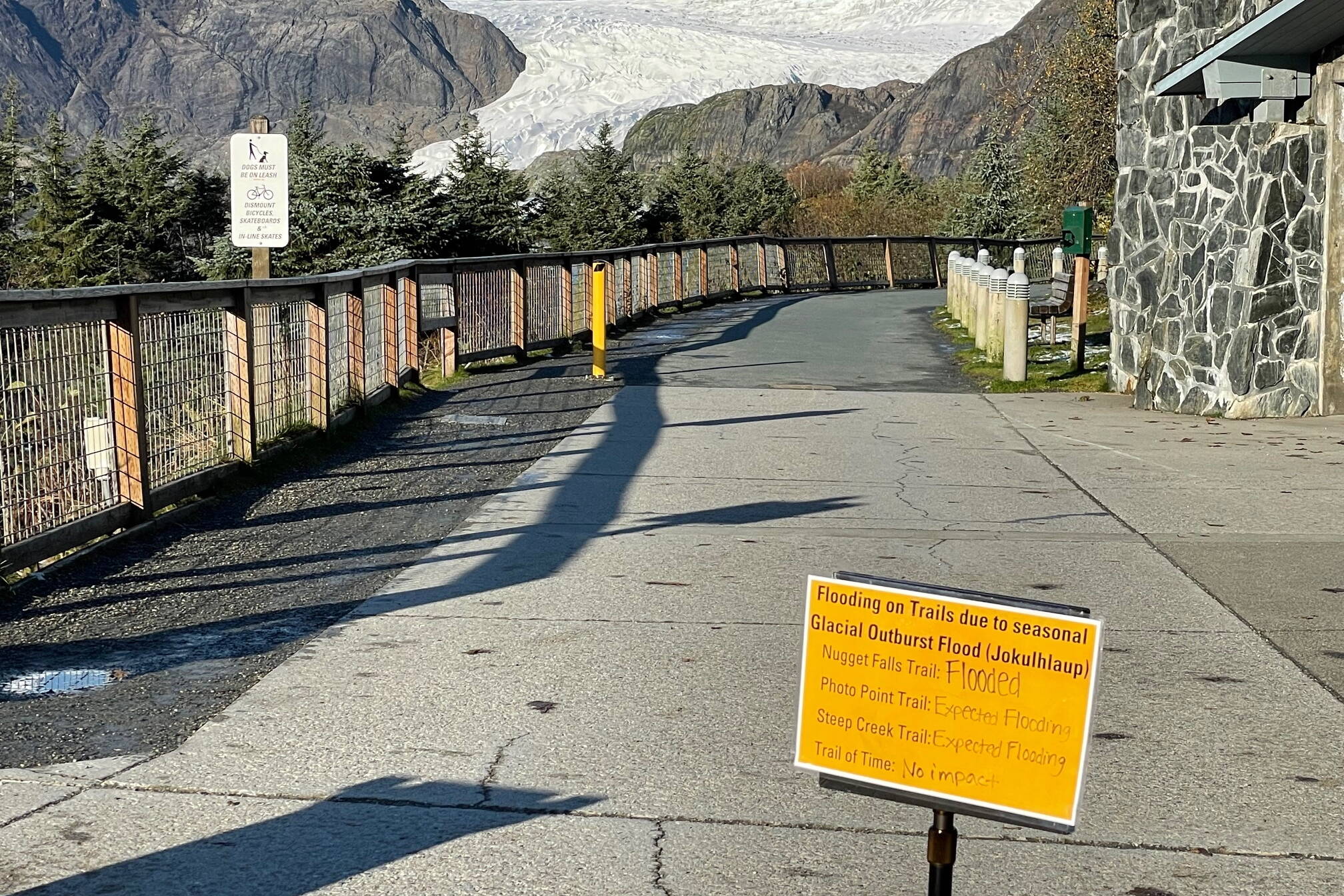 A sign at the Mendenhall Glacier Visitor Center warns people Sunday about flooding on trails due to a glacial outburst flood from Suicide Basin expected to peak early Monday morning. (Laurie Craig / Juneau Empire)