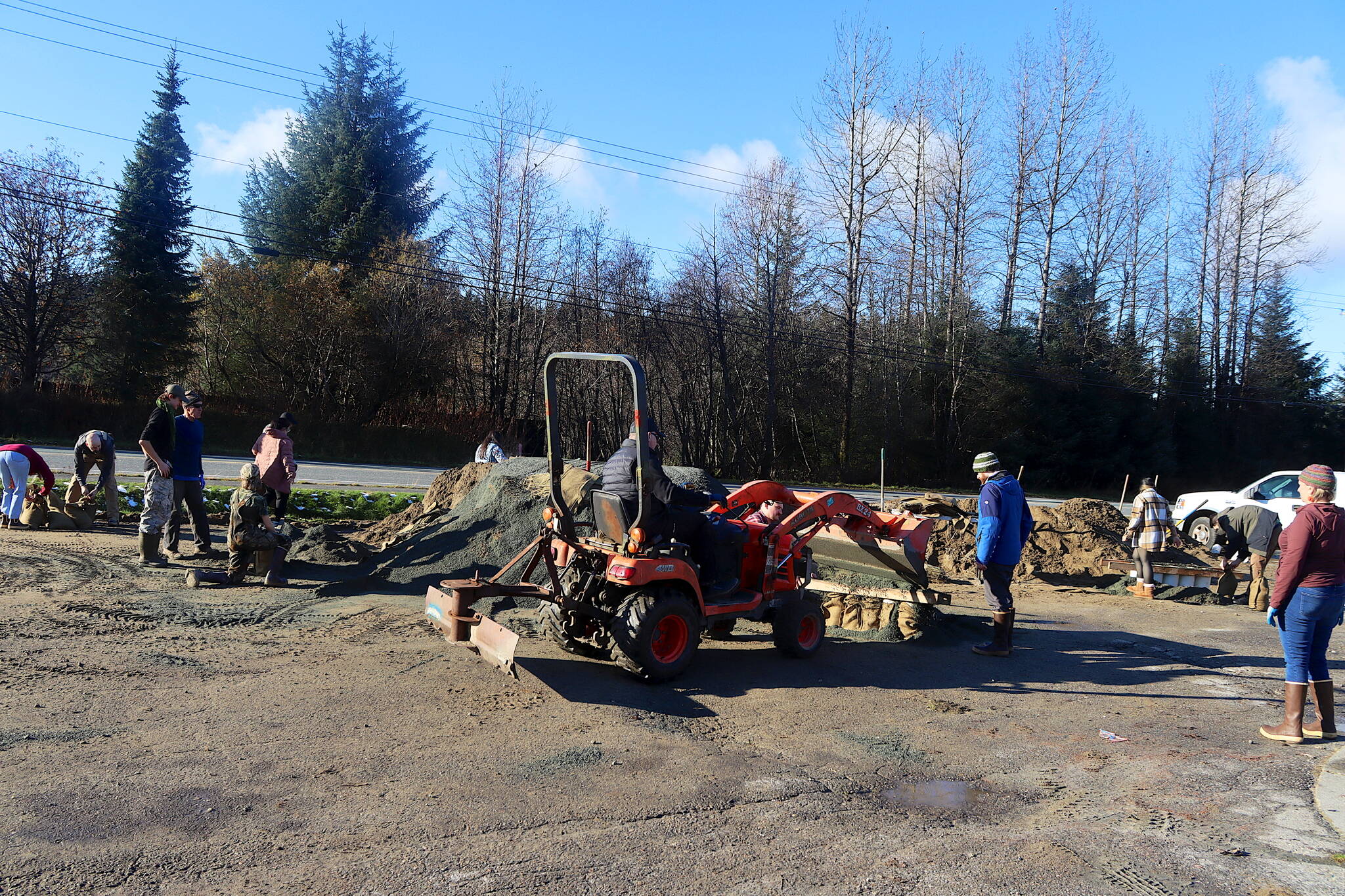 Tom Mattice, Juneau’s emergency programs manager, uses a loader to help residents fill sandbags at Melvin Park on Sunday afternoon. The city is distributing 75,000 sandbags for free, with sand available at the park and the Thunder Mountain Middle School parking lot. (Mark Sabbatini / Juneau Empire)