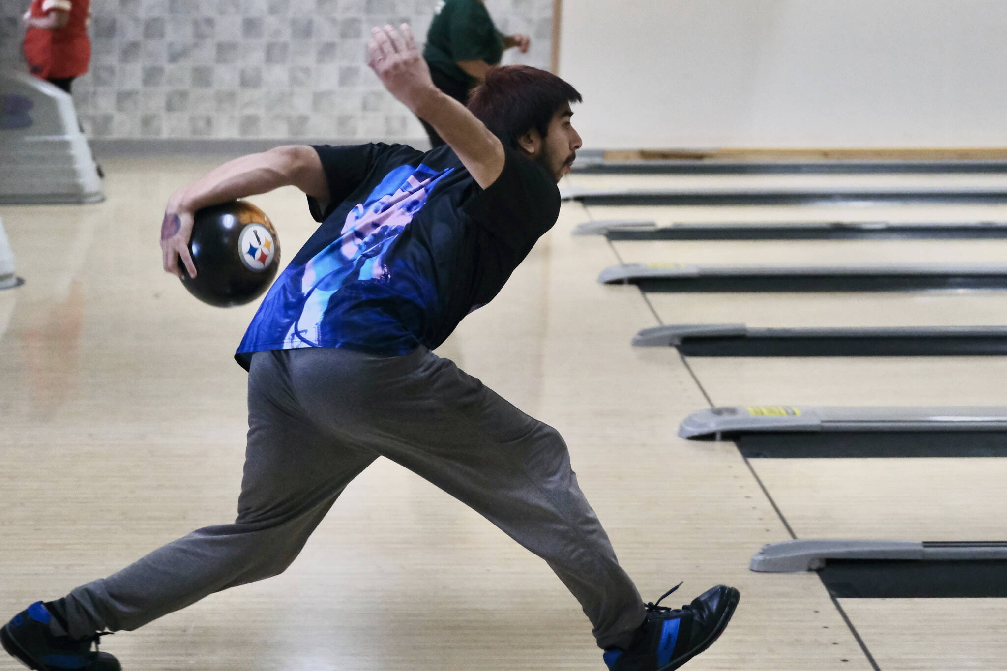 Tyler Anderson delivers a ball during the Juneau Special Olympics bowling games Sunday at Pinz Bowling Alley. (Klas Stolpe/Juneau Empire)