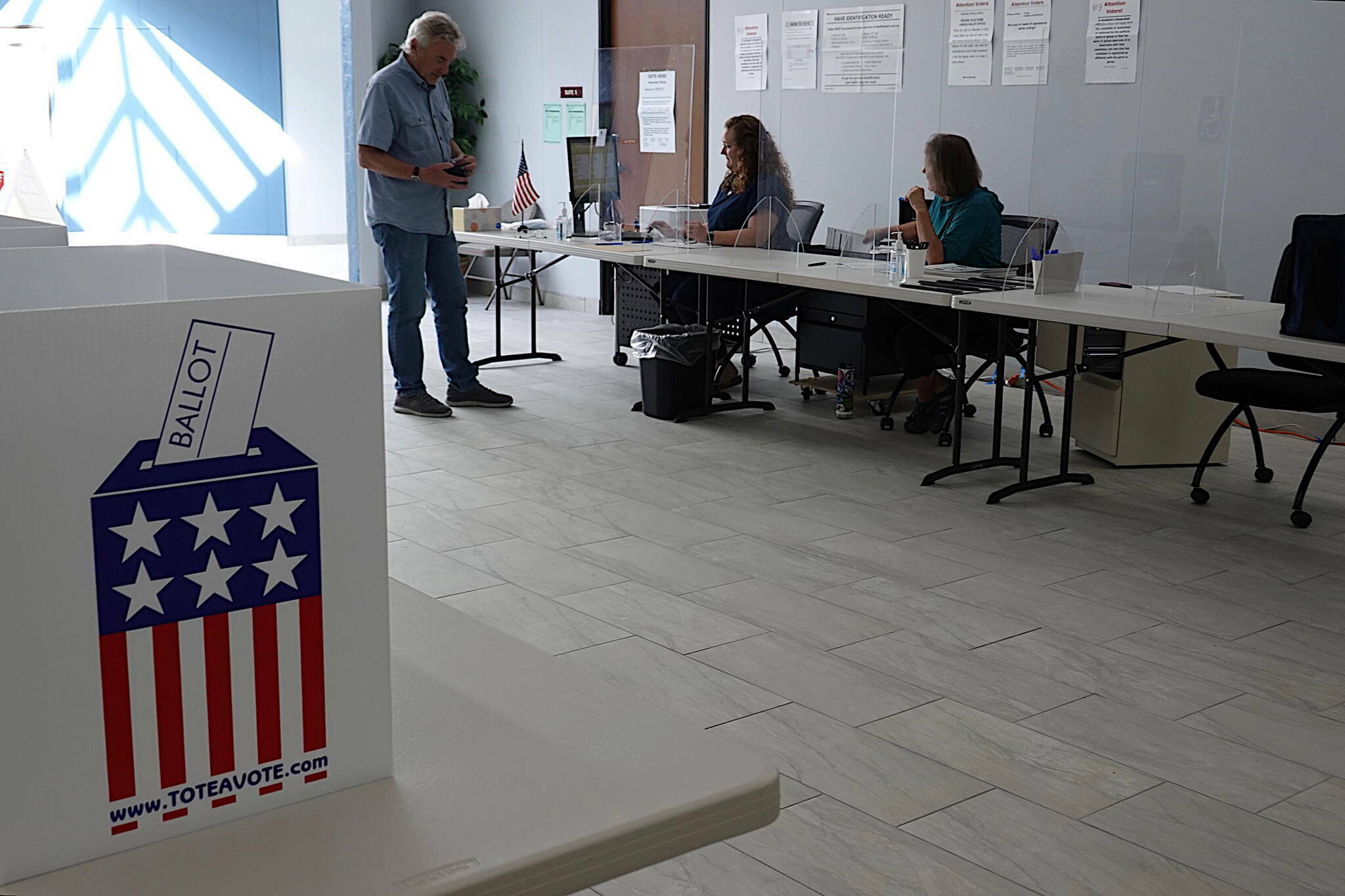 A voter receives his ballot for Alaska’s primary election at the Mendenhall Mall Annex on Aug. 17. (Laurie Craig / Juneau Empire file photo)