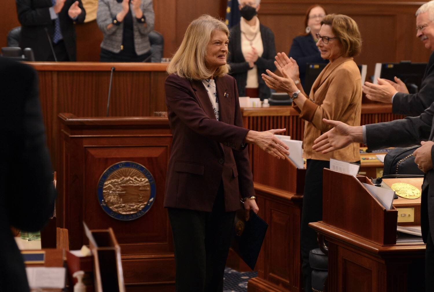 Sen. Lisa Murkowski, R-Alaska, shakes hands with members of the Alaska Legislature on Thursday, Feb. 15, 2024, following her annual address in the state Capitol. (James Brooks/Alaska Beacon)