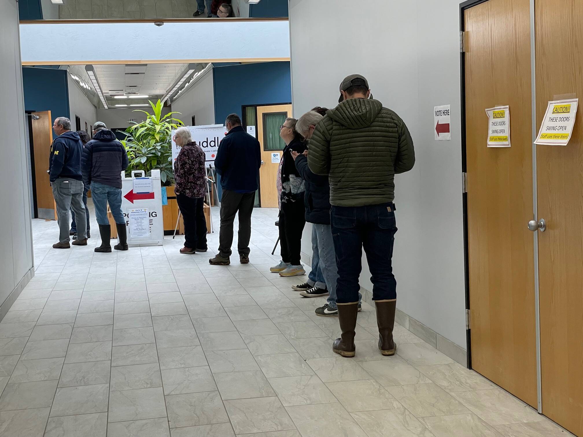 People voting ahead of Election Day line up inside the Mendenhall Mall annex on Friday, Oct. 25. (Laurie Craig / Juneau Empire)