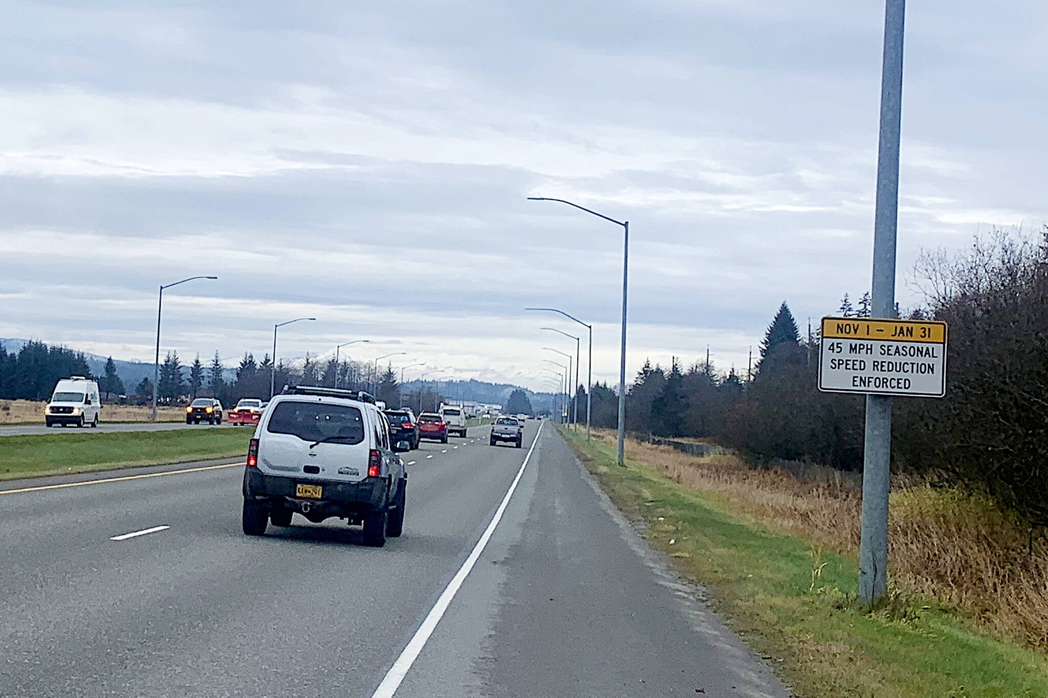 A sign on Egan Drive reminds motorists at midday Friday a lower seasonal speed limit is in effect in an attempt to reduce collisions at the Fred Meyer intersection. (Mark Sabbatini / Juneau Empire)