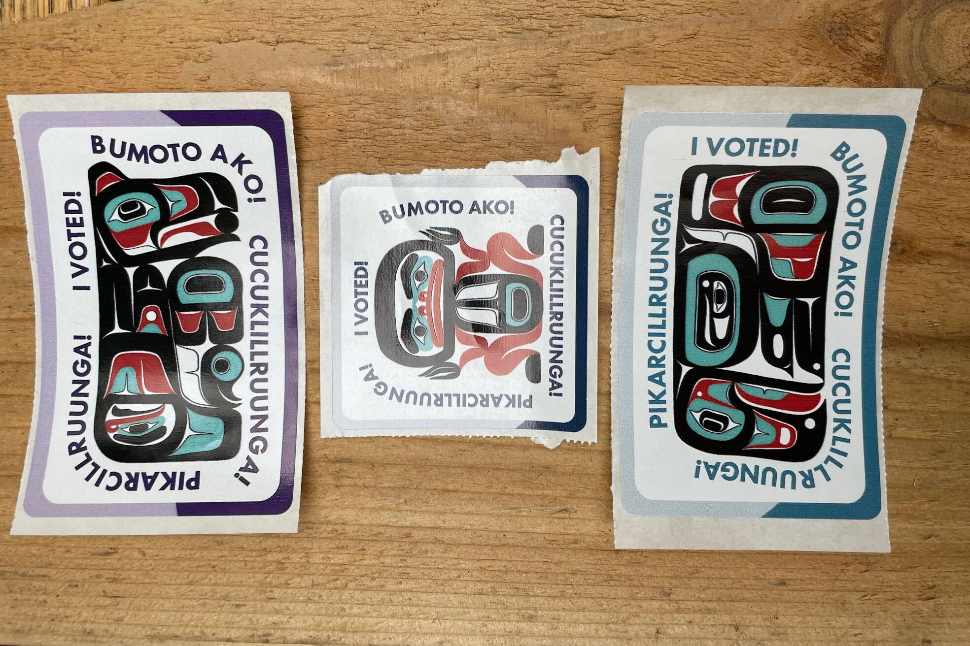 “I voted” stickers featuring Tlingit artwork by James Johnson are displayed on a table at an early voting station at the Mendenhall Mall annex Oct. 30. (Laurie Craig / Juneau Empire file photo)