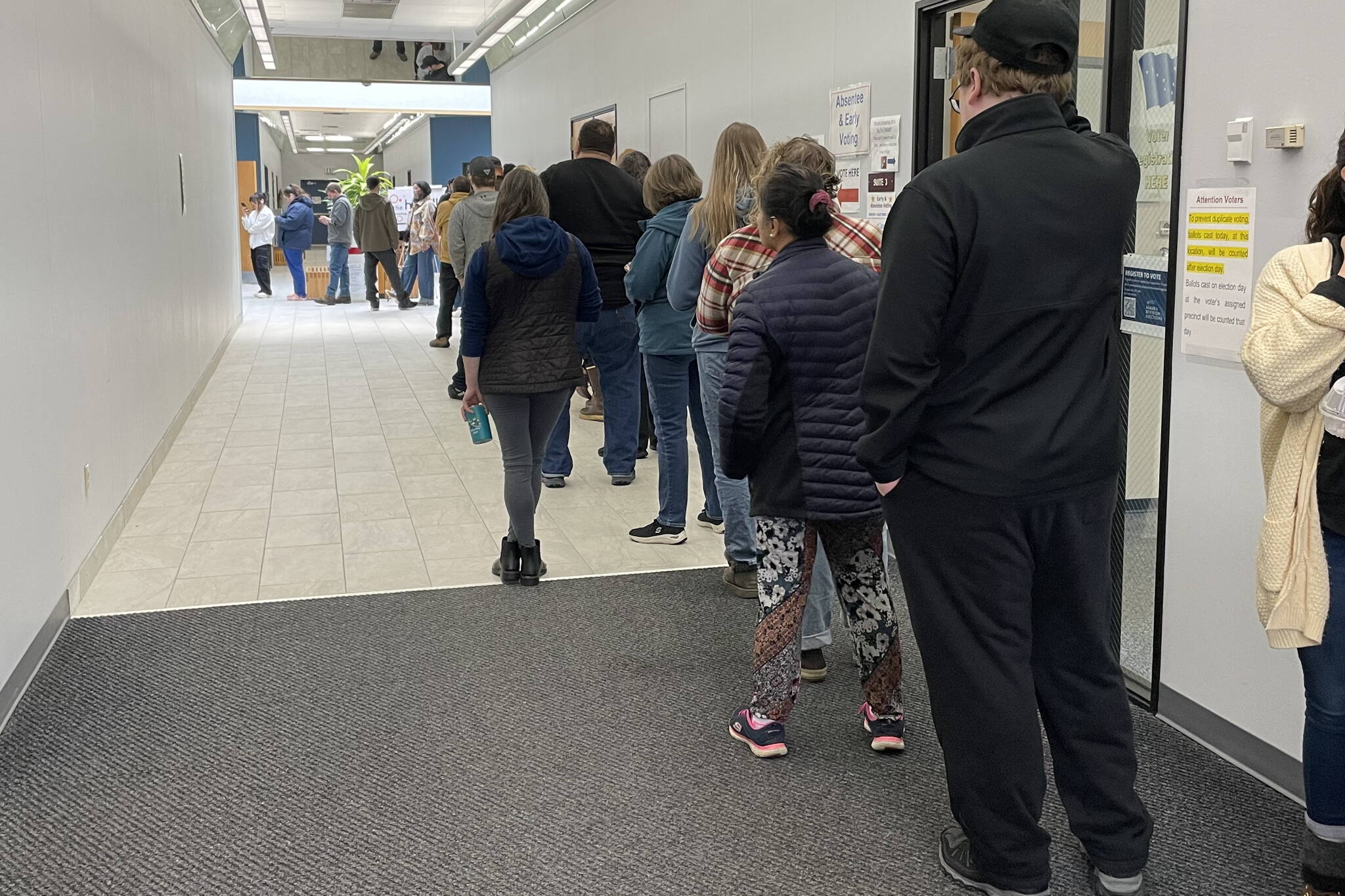 A long line of voters waits Monday at an early voting station at the Mendenhall Mall annex. Voting locations around Juneau will be open Tuesday from 7 a.m. to 8 p.m. (Laurie Craig / Juneau Empire)