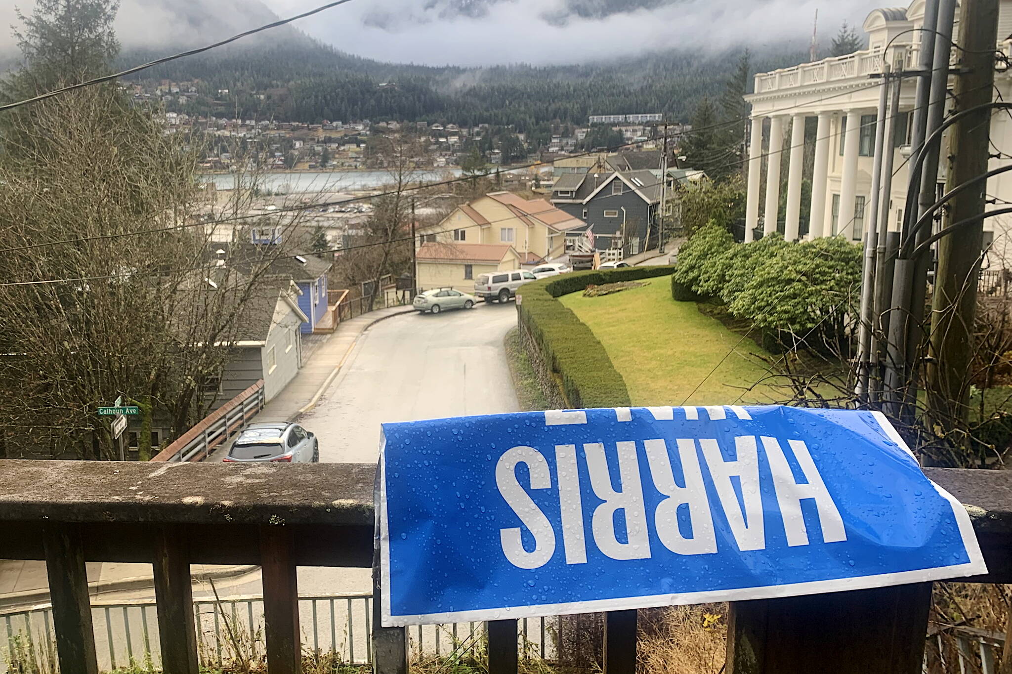 A weather-beaten Kamala Harris campaign sign is seen on the railing along a downtown street on Wednesday. (Mark Sabbatini / Juneau Empire)