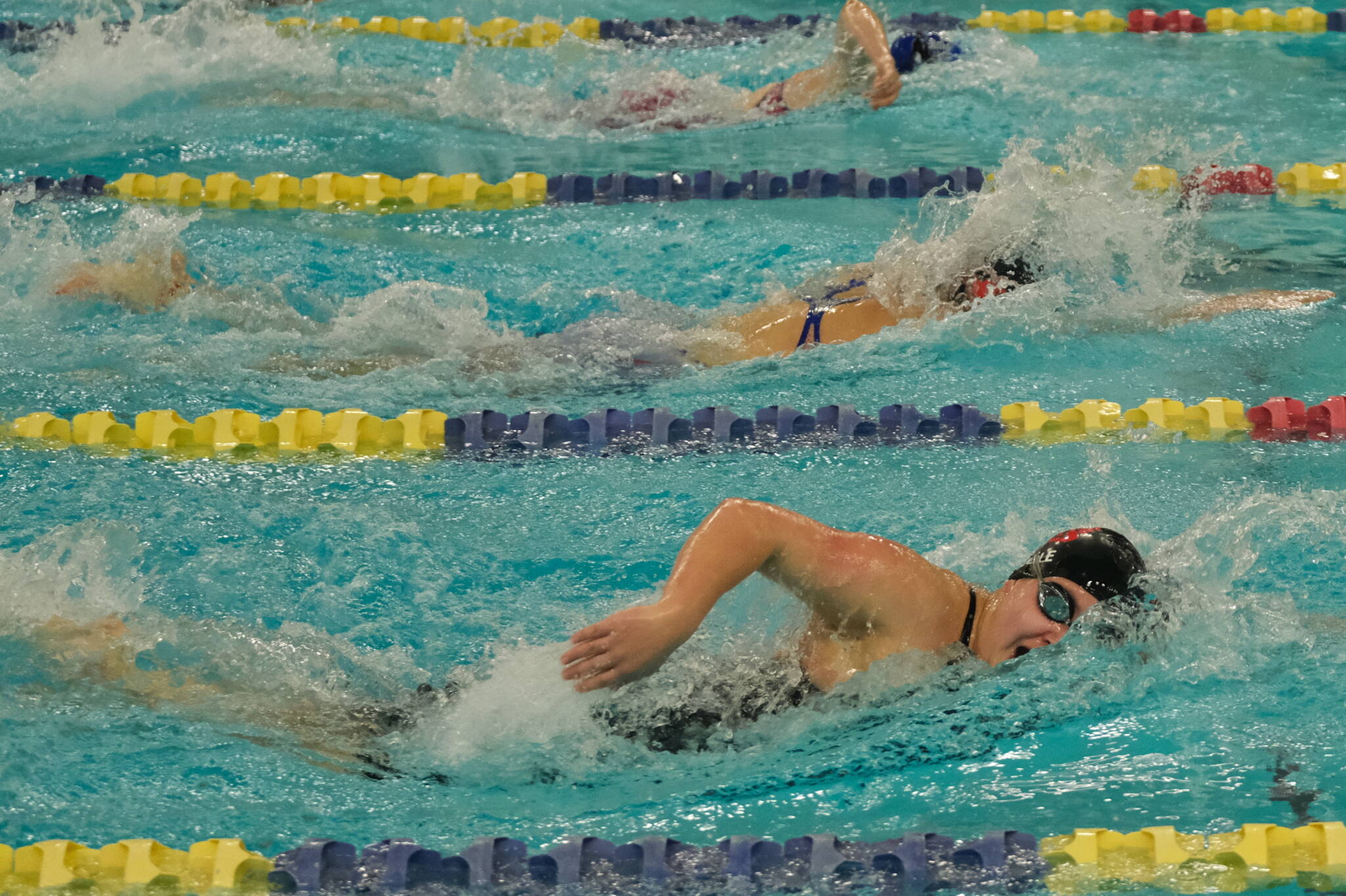 Juneau-Douglas High School: Yadaa.at Kalé sophomore Amy Liddle leads Kenai junior Abigail Price and Palmer junior Kylie Benner en route to winning the girls 200 freestyle title during the ASAA Swim & Dive State Championships on Saturday at Anchorage’s Bartlett High School pool. (Klas Stolpe / Juneau Empire)