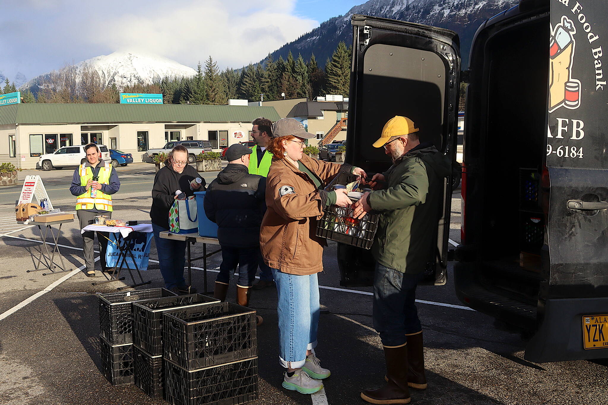 Juneau Assembly Member Ella Adkison (center) helps state Sen. Jesse Kiehl load donated groceries into a van on Saturday during a food drive at Super Bear IGA Supermarket hosted by the Juneau Central Labor Council. (Mark Sabbatini / Juneau Empire)