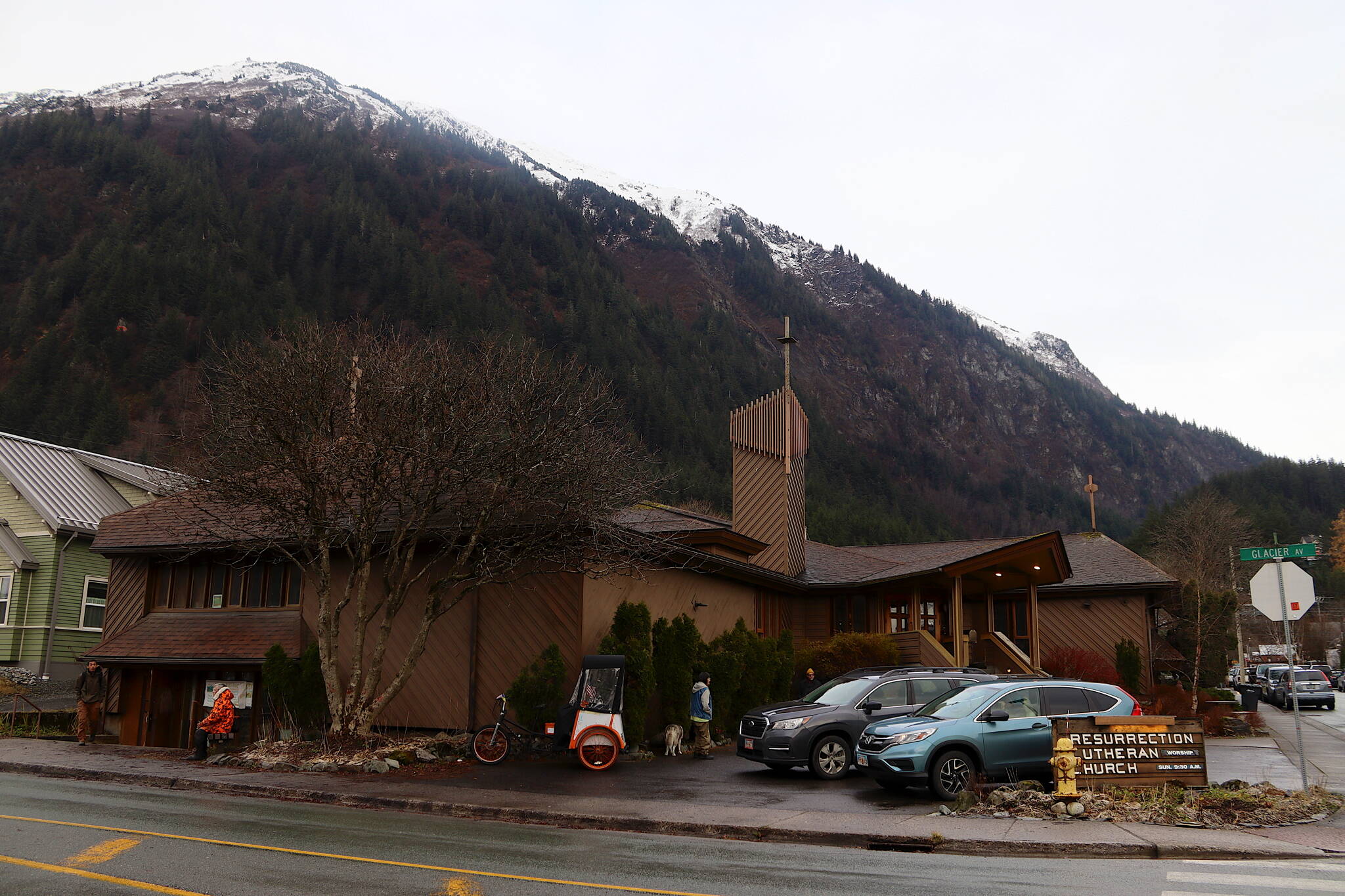 People gather outside Resurrection Lutheran Church as it hosts its weekly food pantry on Tuesday afternoon. (Mark Sabbatini / Juneau Empire)