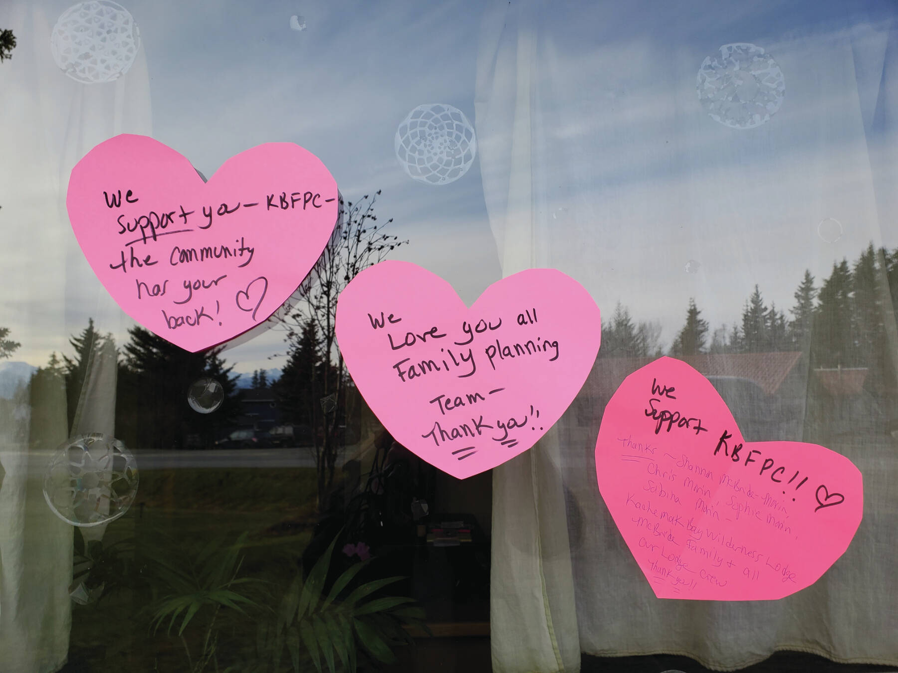 Letters of support are posted to the window of the Kachemak Bay Family Planning Clinic on Tuesday, Nov. 12, 2024, following a shooting incident on Monday, Nov. 11 at 5:45 a.m. in Homer. (Delcenia Cosman/Homer News)