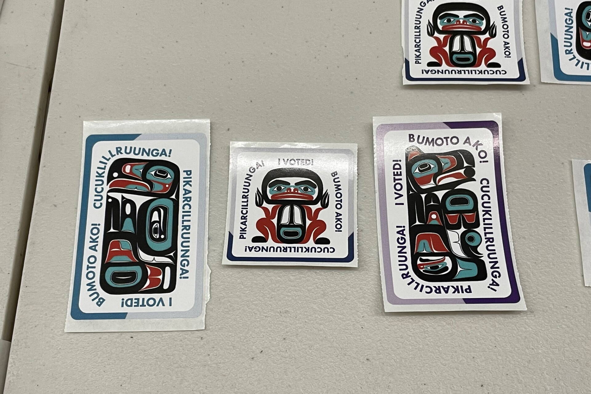 Tlingit “I Voted” stickers are displayed on a table at the voting station at the Mendenhall Mall during early voting in the Nov. 5 general election. (Laurie Craig / Juneau Empire file photo)