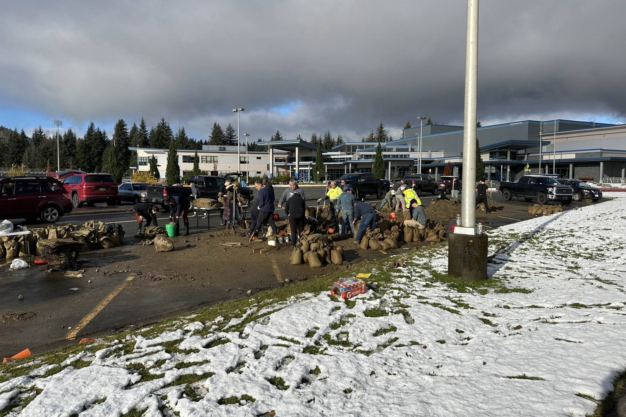 People living in areas affected by flooding from Suicide Basin pick up free sandbags on Oct. 20 at Thunder Mountain Middle School. (City and Borough of Juneau photo)