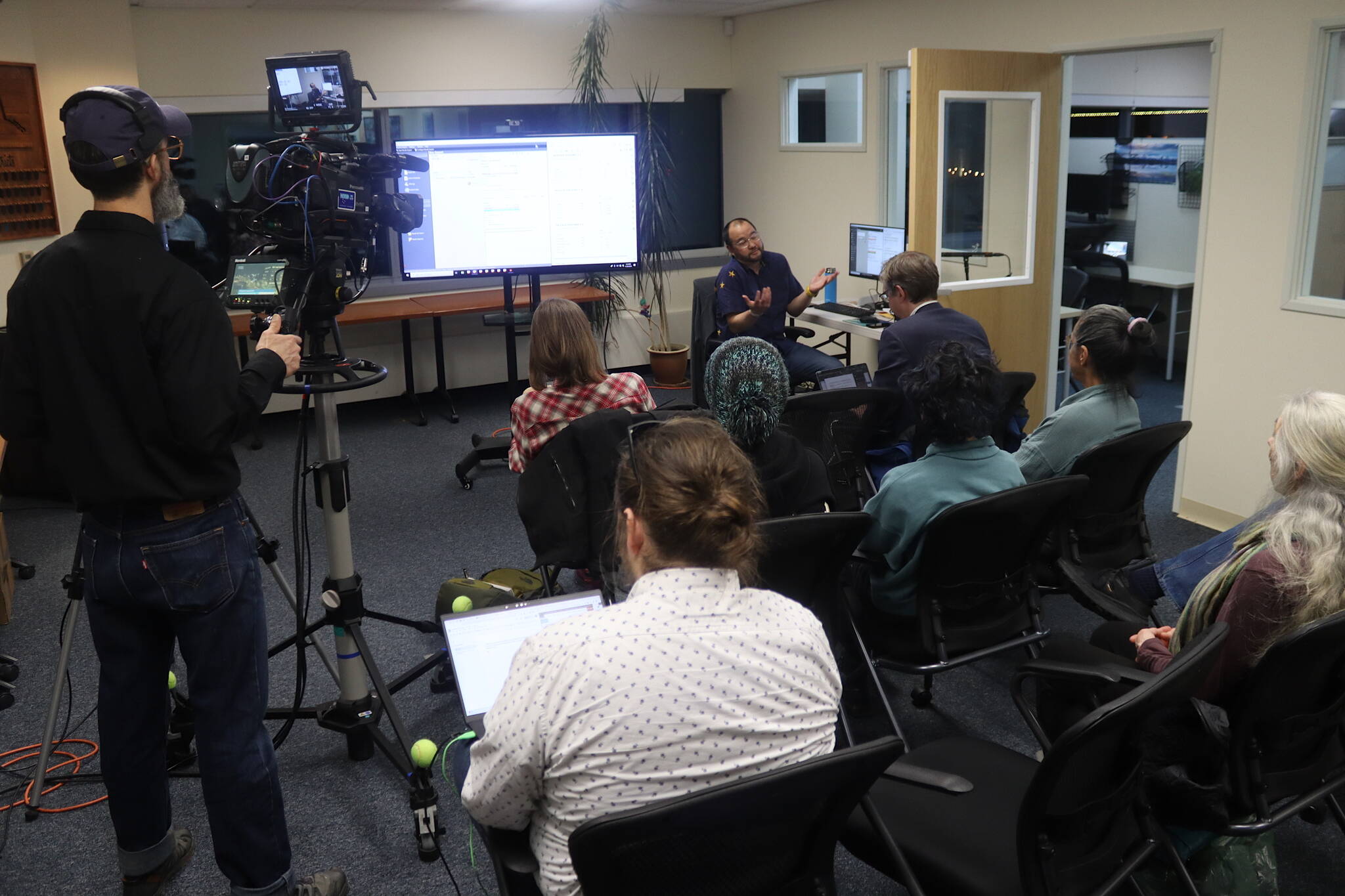 Media members and other observers gather at the Alaska Division of Elections office on Wednesday evening as the results of all ballots, including ranked choice tabulations, were announced. (Mark Sabbatini / Juneau Empire)