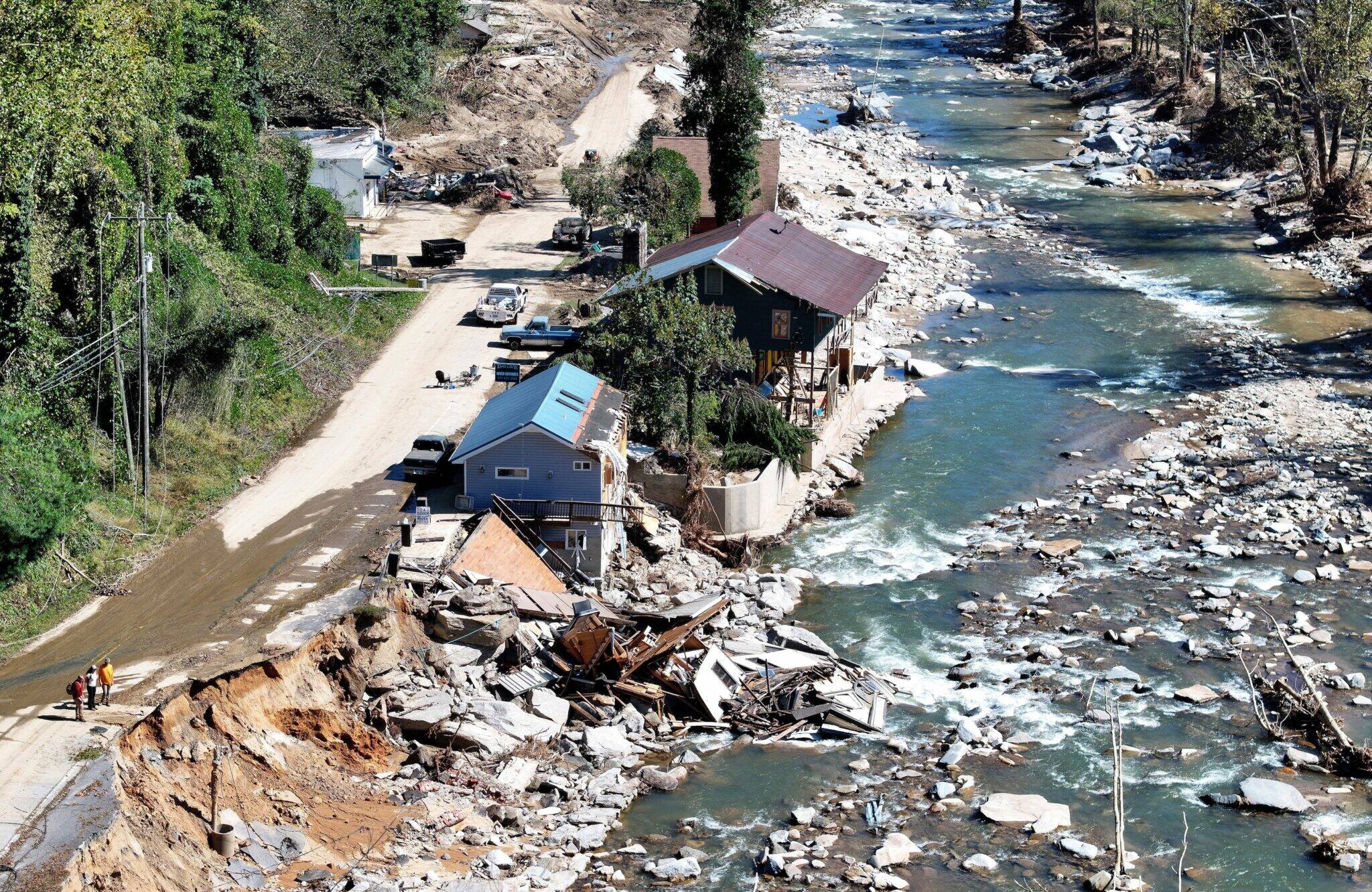 An aerial view of people standing near destroyed and damaged buildings in the aftermath of Hurricane Helene flooding on Oct. 8, 2024 in Bat Cave, North Carolina. (Mario Tama/Getty Images)