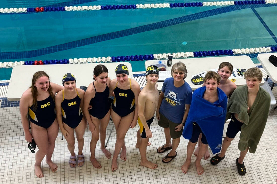 Glacier Swim Club members, left-to-right, Cora Soboleff, Clara Van Kirk, Natalie MacKinnon, Ellie Higgins, Leon Ward, coach Lisa Jones, Zach Holden, Josh Ely and Henry Thatcher during the 2024 November Rain swim meet at Petersburg last weekend. (Photo courtesy Glacier Swim Club)