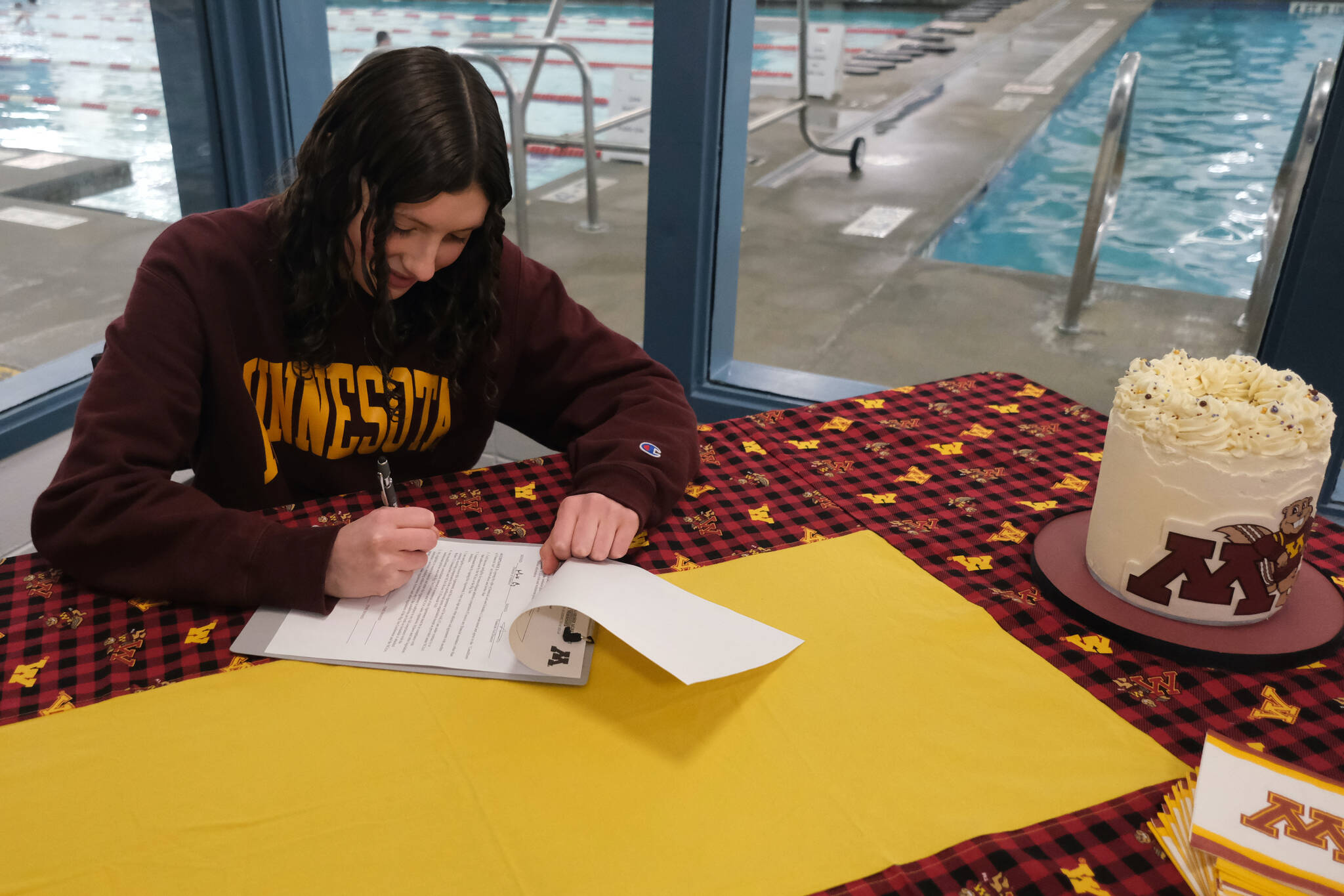 Juneau-Douglas High School: Yadaa.at Kalé senior Emma Fellman signs a national letter of intent on Thursday at Augustus Brown Pool to attend and swim for the University of Minnesota. (Klas Stolpe / Juneau Empire)