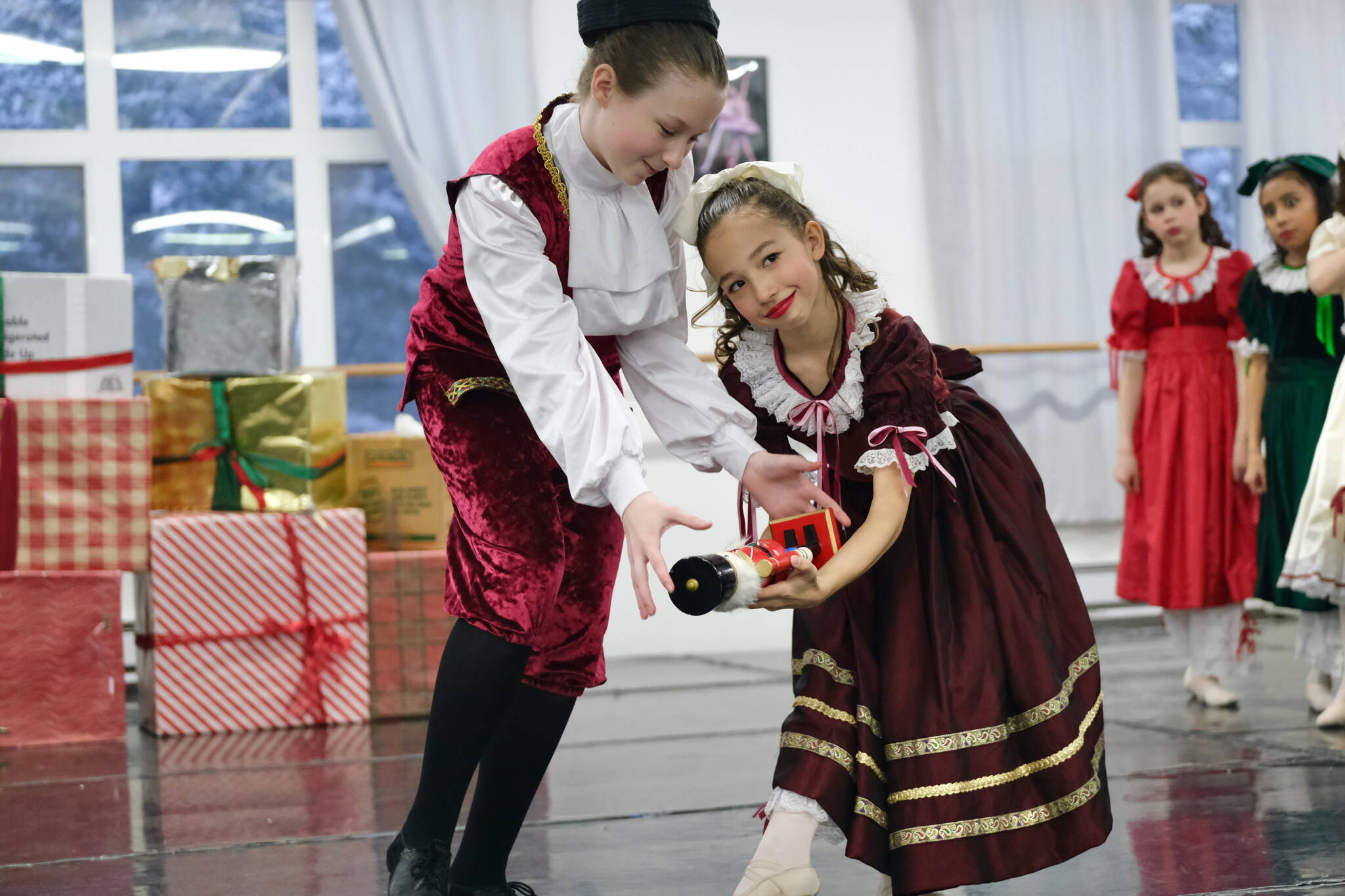 Fritz, played by Dani Hayes, steals the Nutcracker doll from Clara, played by Sachiko Marks, in Juneau Dance Theatre’s production of “The Nutcracker” during dress rehearsal Sunday at the JDT studio. (Klas Stolpe / Juneau Empire)