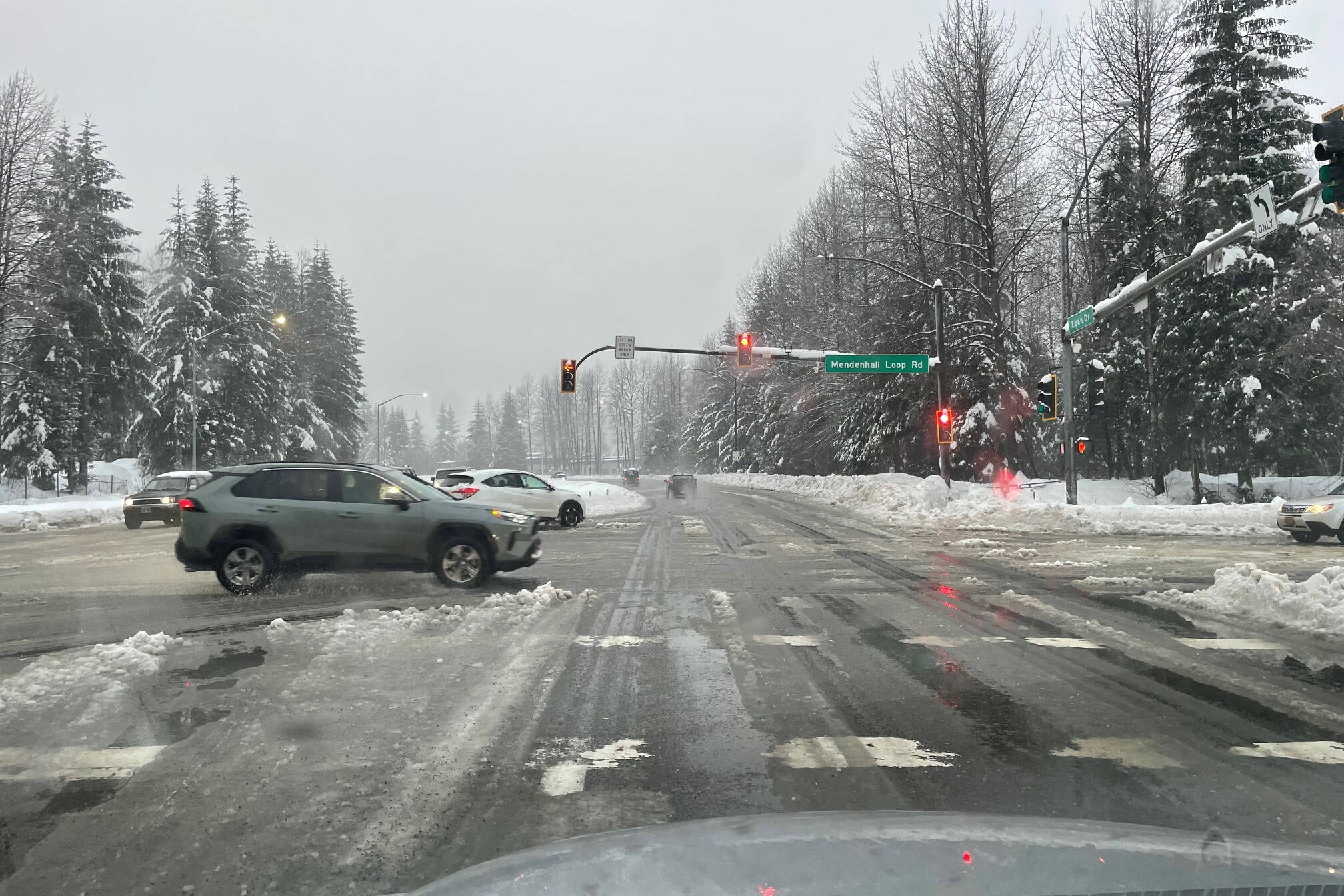 Traffic navigates a busy intersection covered with ice and slush on Monday afternoon. (Laurie Craig / Juneau Empire file photo)