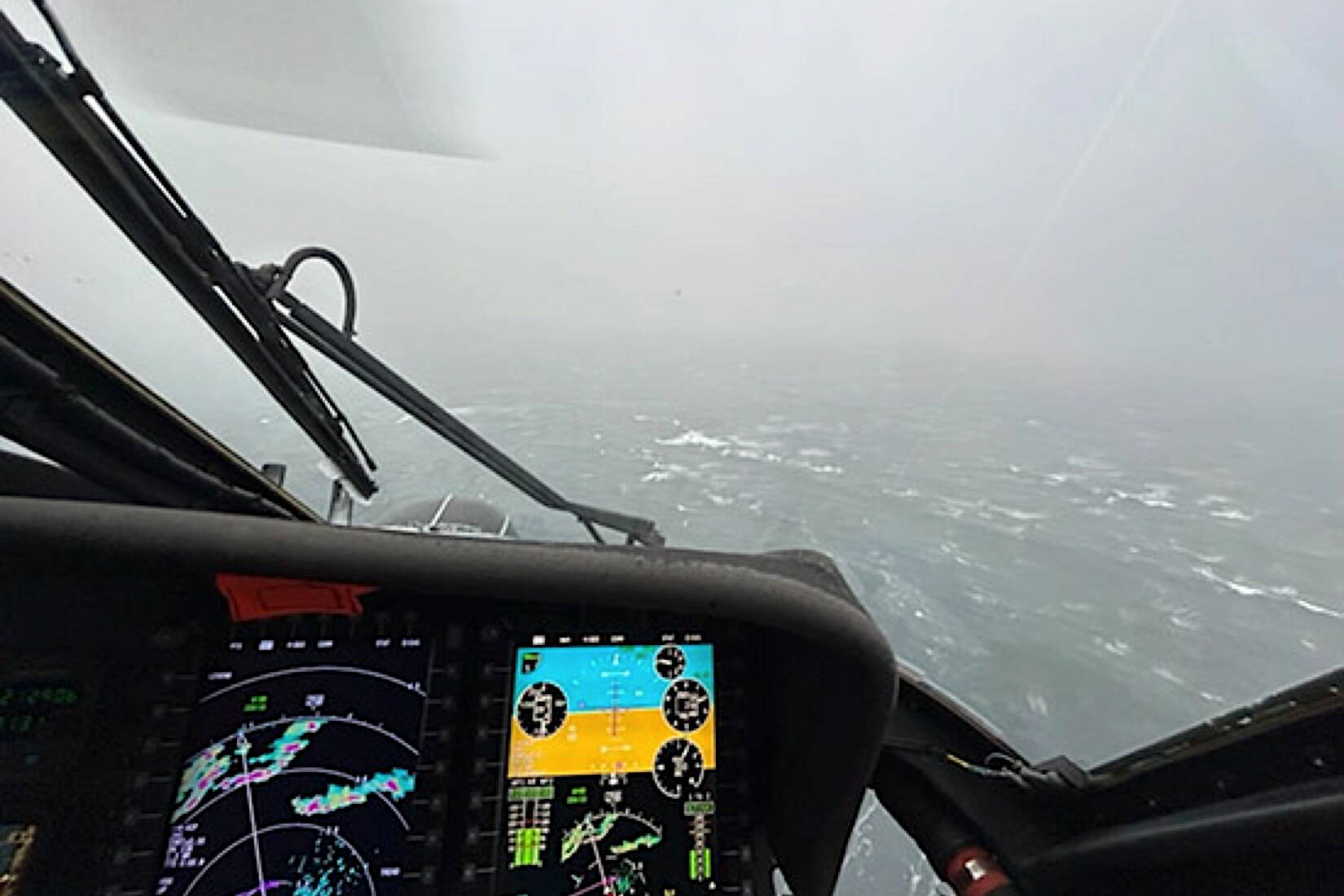 An MH-60 Jayhawk helicopter aircrew conducts an on-scene search for five missing people after the fishing vessel Wind Walker was reported to have capsized near Courverden Point Sunday. The combined searches covered over 108 square nautical miles within a span of 24 hours. (U.S. Coast Guard photo by Cmdr. Paul Johansen)