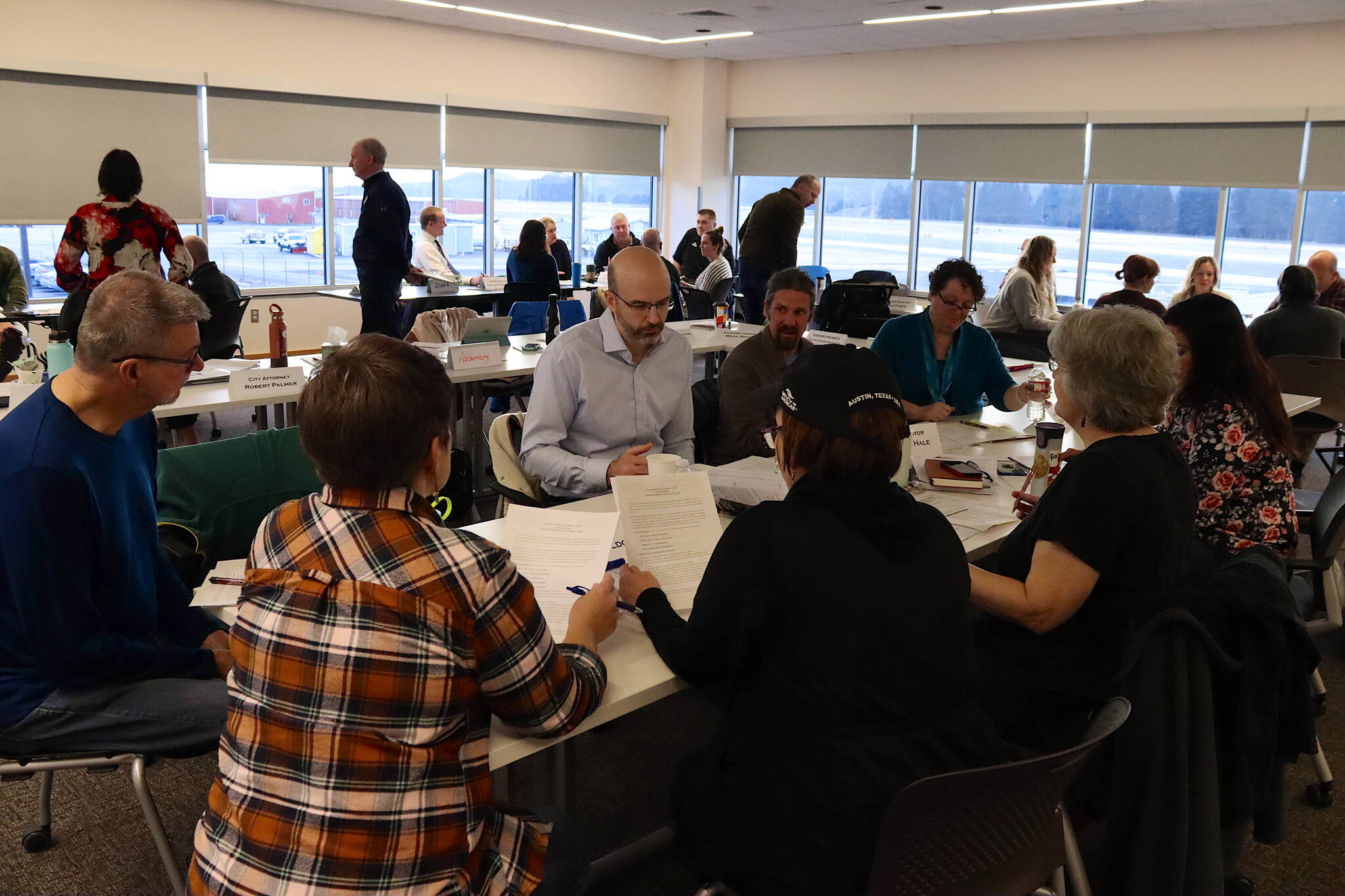 Juneau Assembly members, city administrative leaders and other officials gather for the Assembly’s annual retreat where they discuss policy and budget goals for the coming year in the Juneau International Airport’s conference room on Dec. 2, 2023. This year’s retreat is scheduled Saturday at the same location. (Mark Sabbatini / Juneau Empire file photo)