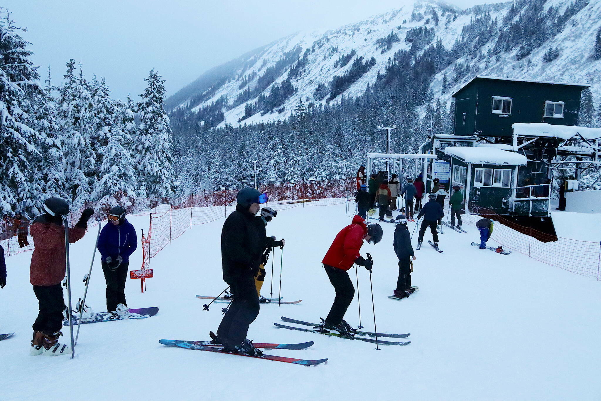 A line at the Ptarmigan lift gains new arrivals shortly after Eaglecrest Ski Area begins operating for the 2023-24 ski season on Wednesday, Dec. 20, 2023. The Ptarmigan lift will be the only one operating to the top of the mountain this season due to mechanical problems with the Black Bear lift. (Mark Sabbatini / Juneau Empire file photo)