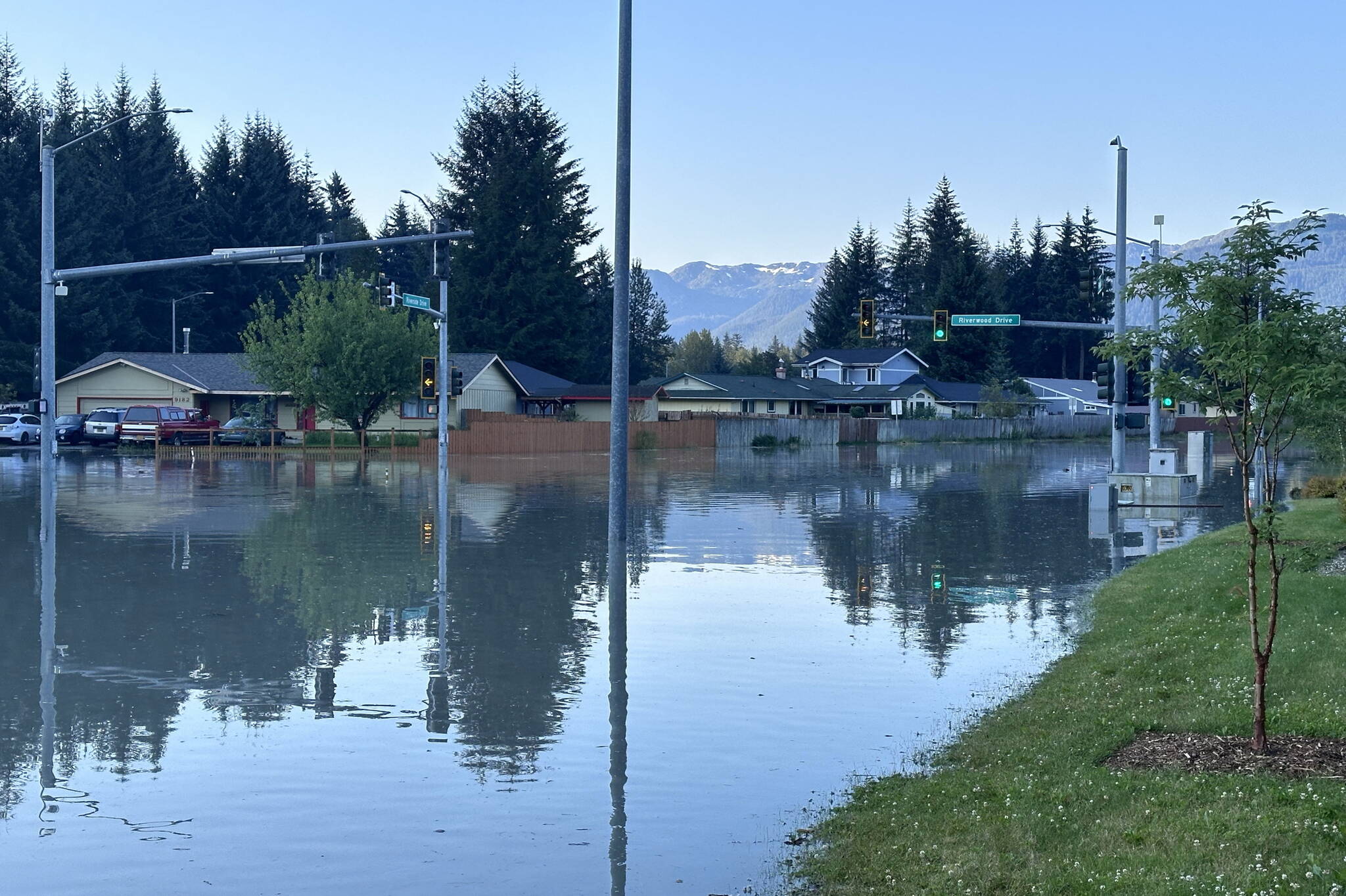 An intersection in the Mendenhall Valley is submerged during record flooding from Suicide Basin on Aug. 6. A report published last week states such flooding is the result of glacier melt occurring due to climate change. (City and Borough of Juneau photo)