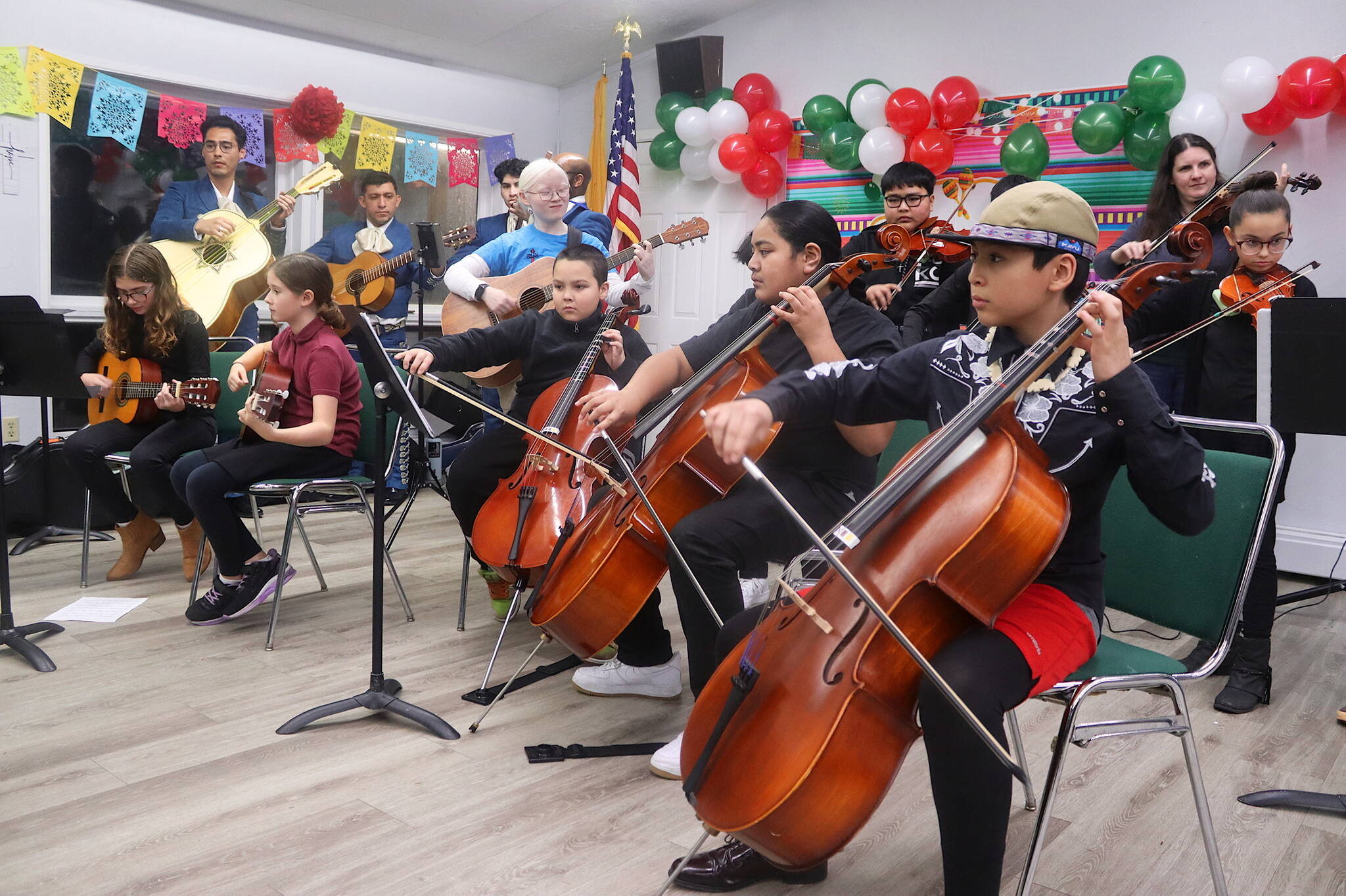 Hans Rivera (foreground) plays a Mexican song on cello with other Juneau Alaska Music Matters students and a mariachi band from Anchorage as part of a Feast Day of Our Lady of Guadalupe celebration at St. Paul’s Catholic Church on Sunday. (Mark Sabbatini / Juneau Empire)