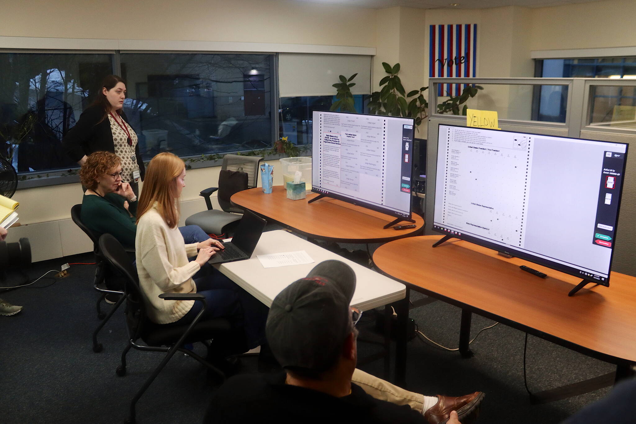 Alaska Division of Elections officials on Thursday display scanned ballots from the Nov. 5 election on screens for attorneys monitoring a recount of a measure to repeal ranked choice in the state. (Mark Sabbatini / Juneau Empire file photo)