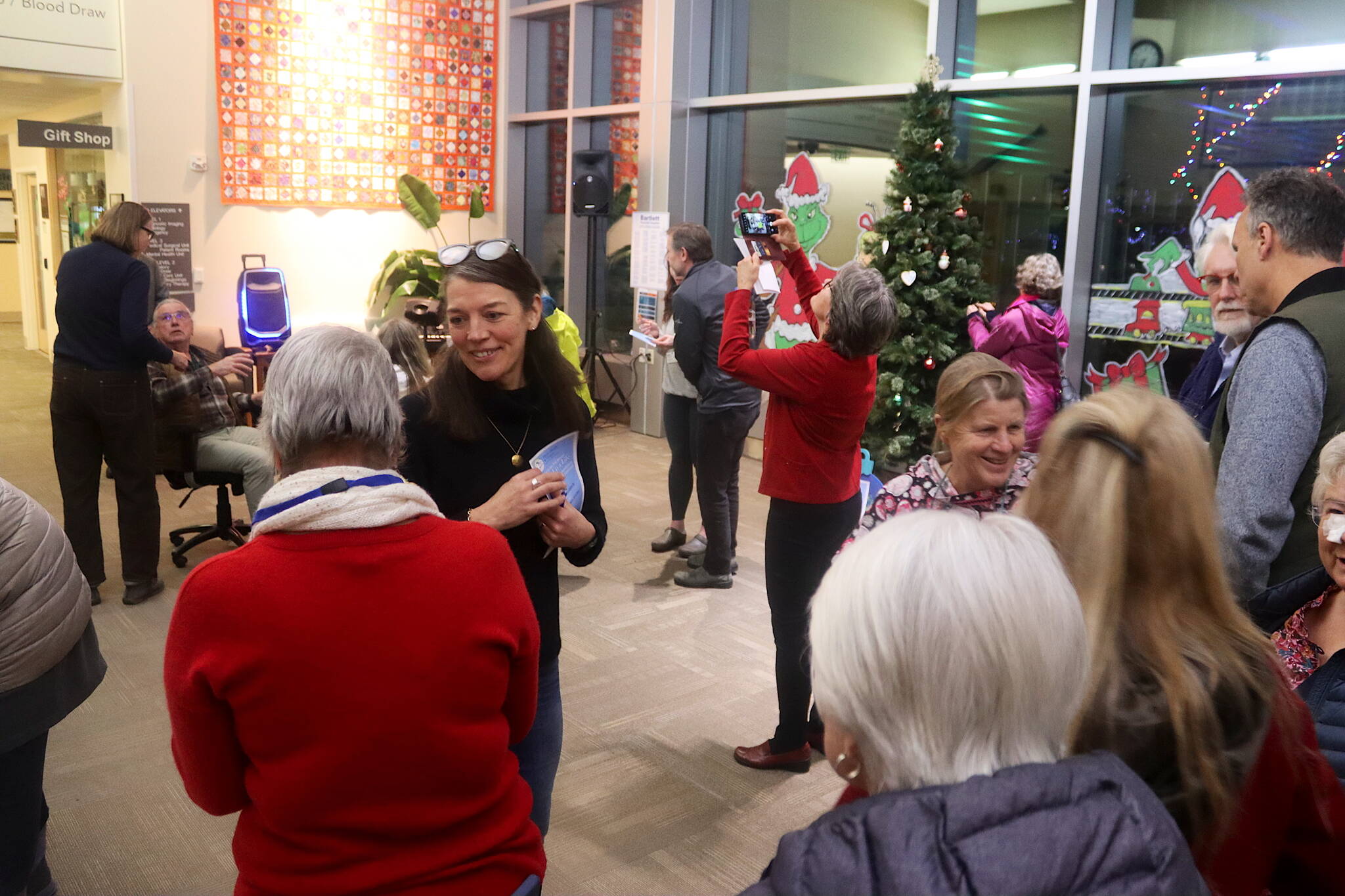 Members of the Home Health and Hospice program at Bartlett Regional Hospital, and family members of people who’ve been in such programs, gather for “Light Up a Life” community celebration Friday evening at the hospital. (Mark Sabbatini / Juneau Empire)