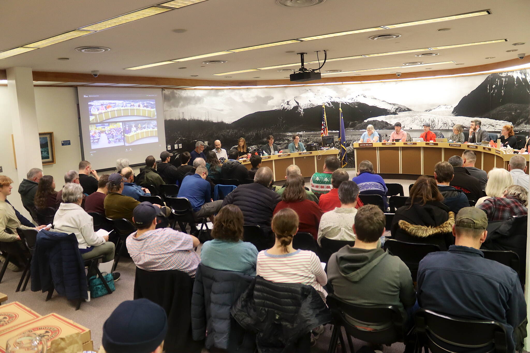 Dozens of residents pack into a Juneau Assembly meeting at City Hall on Monday night, where a proposal that would require property owners in flood-vulnerable areas to pay nearly $8,000 fee apiece for the installation of protective flood barriers. (Mark Sabbatini / Juneau Empire)