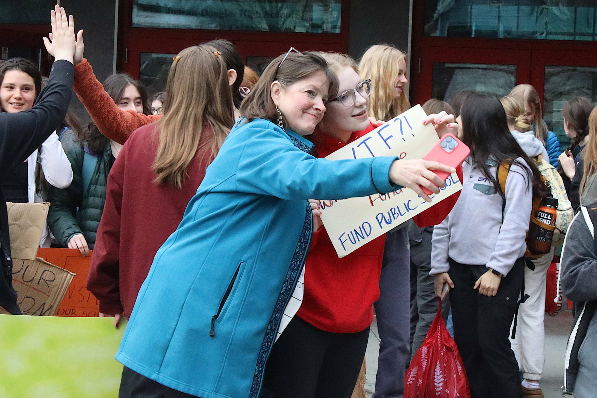 Rep. Alyse Galvin, an Anchorage independent, takes a photo with Meadow Stanley, a senior at Juneau-Douglas High School: Yadaa.at Kalé on April before they took part in a march protesting education funding from the school to the Alaska State Capitol. (Mark Sabbatini / Juneau Empire)