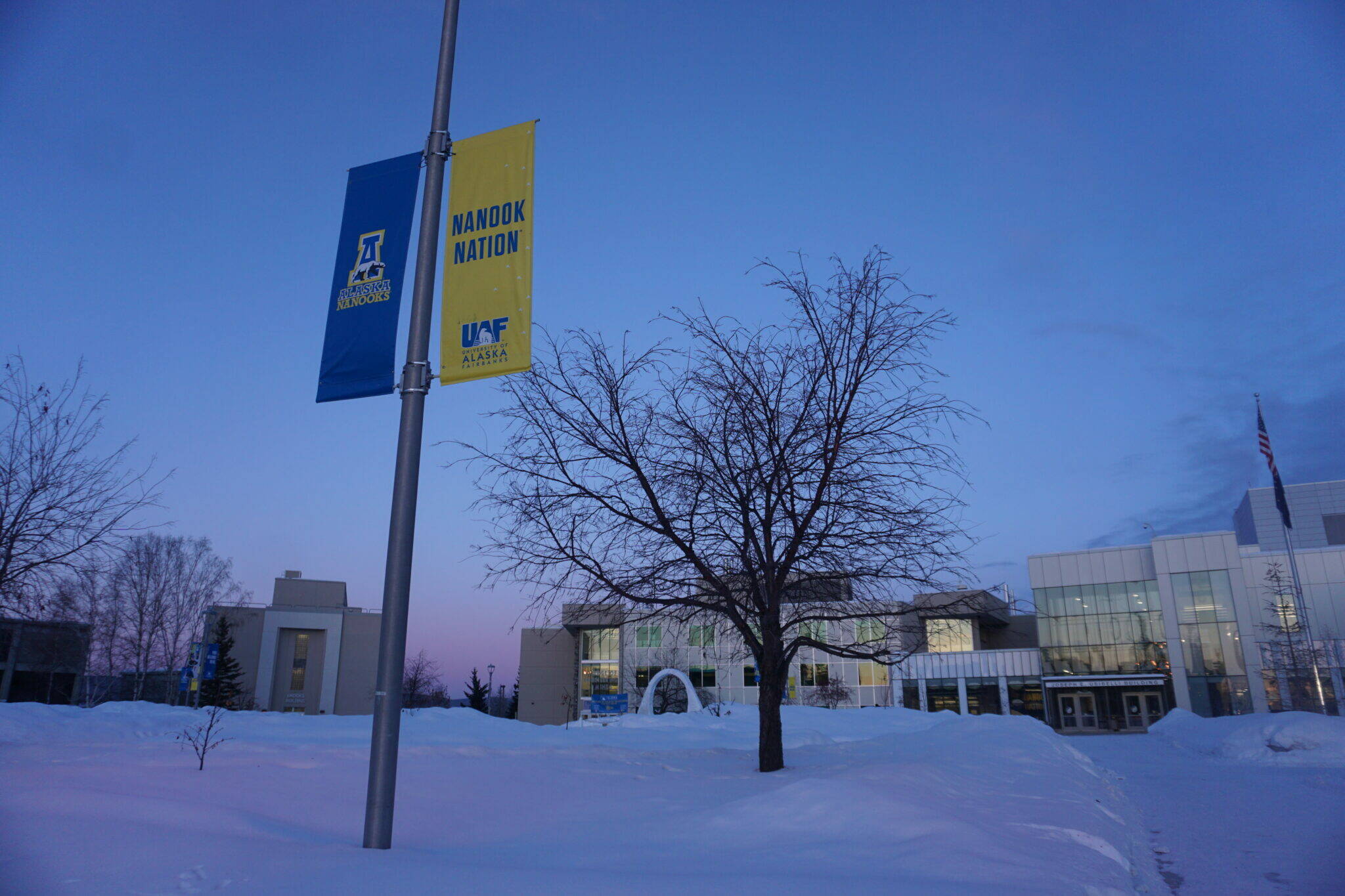 Sunset hues color the sky and the snow at the University of Alaska Fairbanks campus on Feb. 26, 2024. The University of Alaska system and the union representing nearly 1,100 faculty members and postdoctoral fellows are headed into federal mediation in January. (Yereth Rosen/Alaska Beacon)