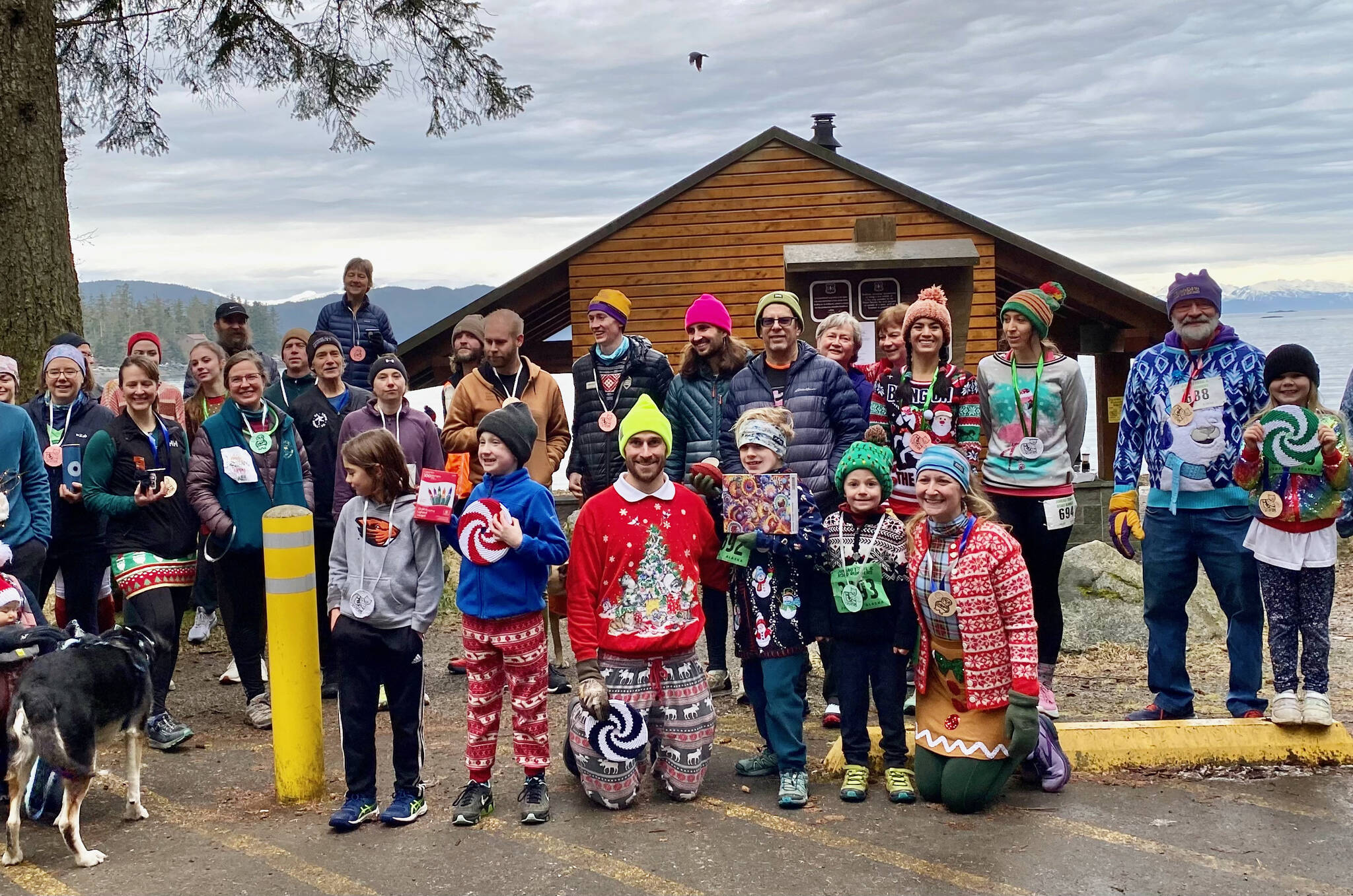 Participants in the 2024 Solstice Sweater Shuffle pose for a photo at Lena Beach campground. (Photo courtesy race directors)