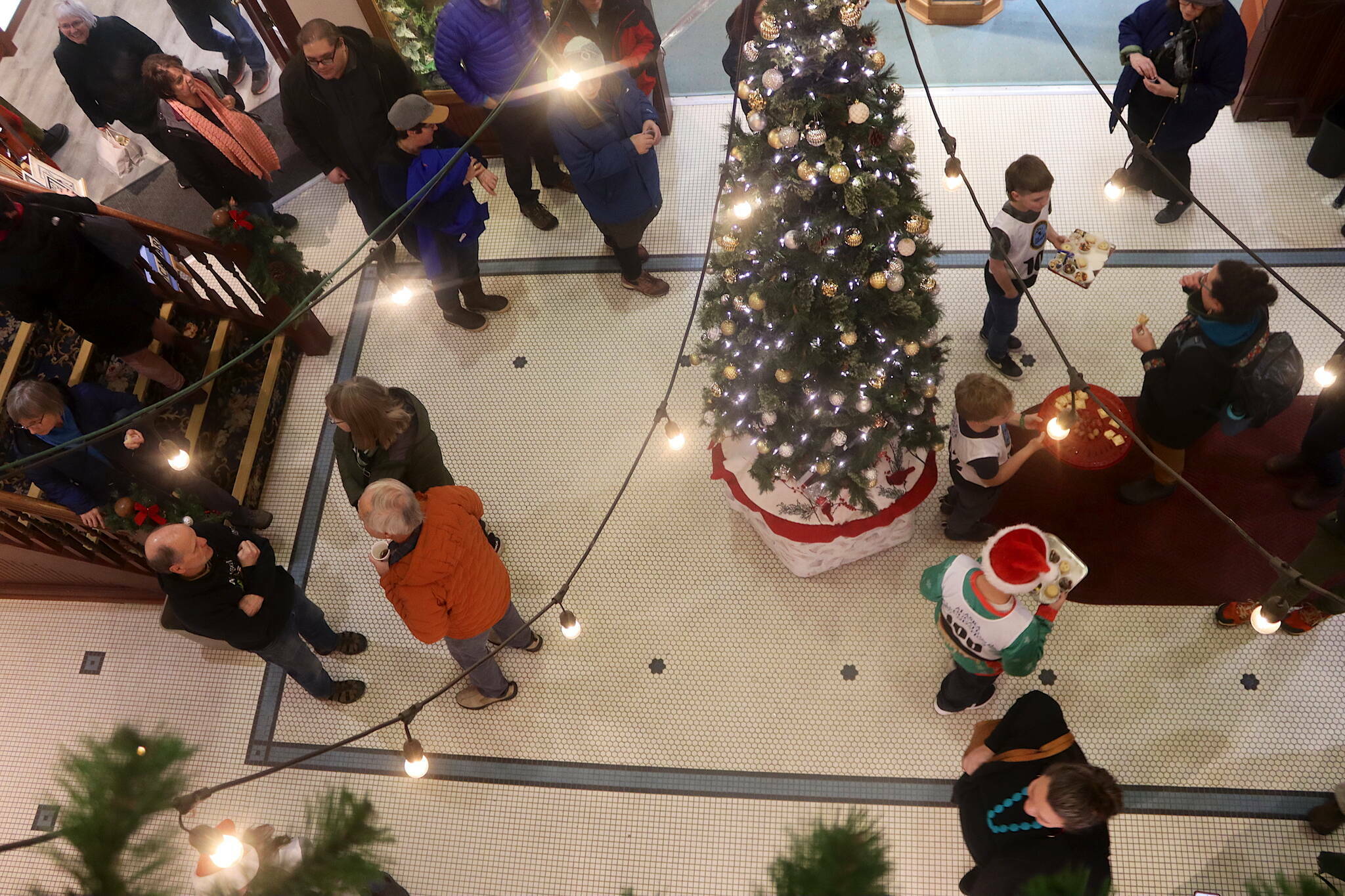 Members of the Juneau Ski Team offer cookies and other treats to people in the Senate Mall during this year’s Gallery Walk on Friday, Dec. 6. (Mark Sabbatini / Juneau Empire file photo)