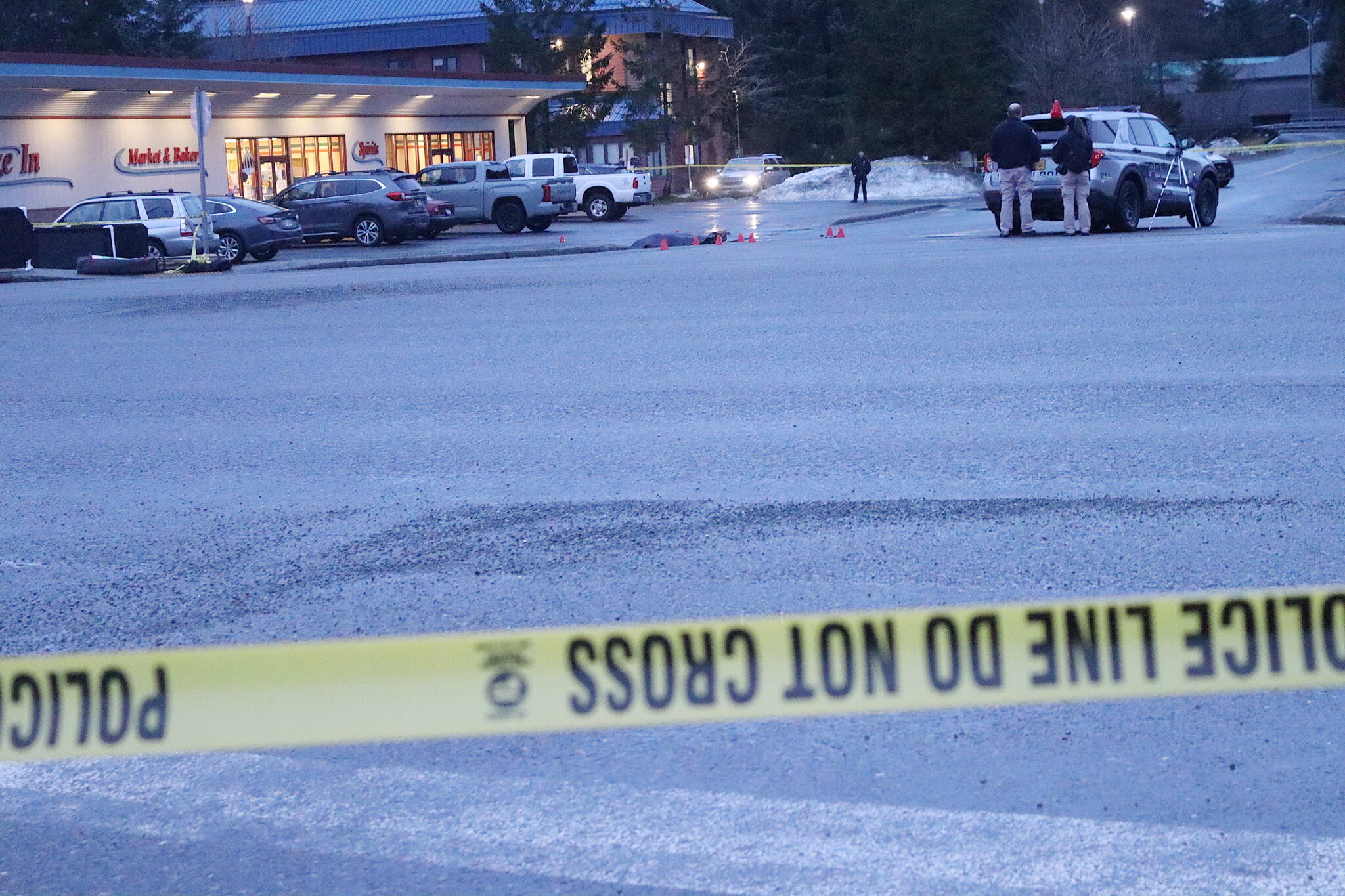 Juneau Police Department officers close off an area around the intersection of Glacier Highway and Trout Street on Wednesday morning following an officer-involved shooting that resulted in the death of a woman believed to be experiencing homelessness. (Mark Sabbatini / Juneau Empire)