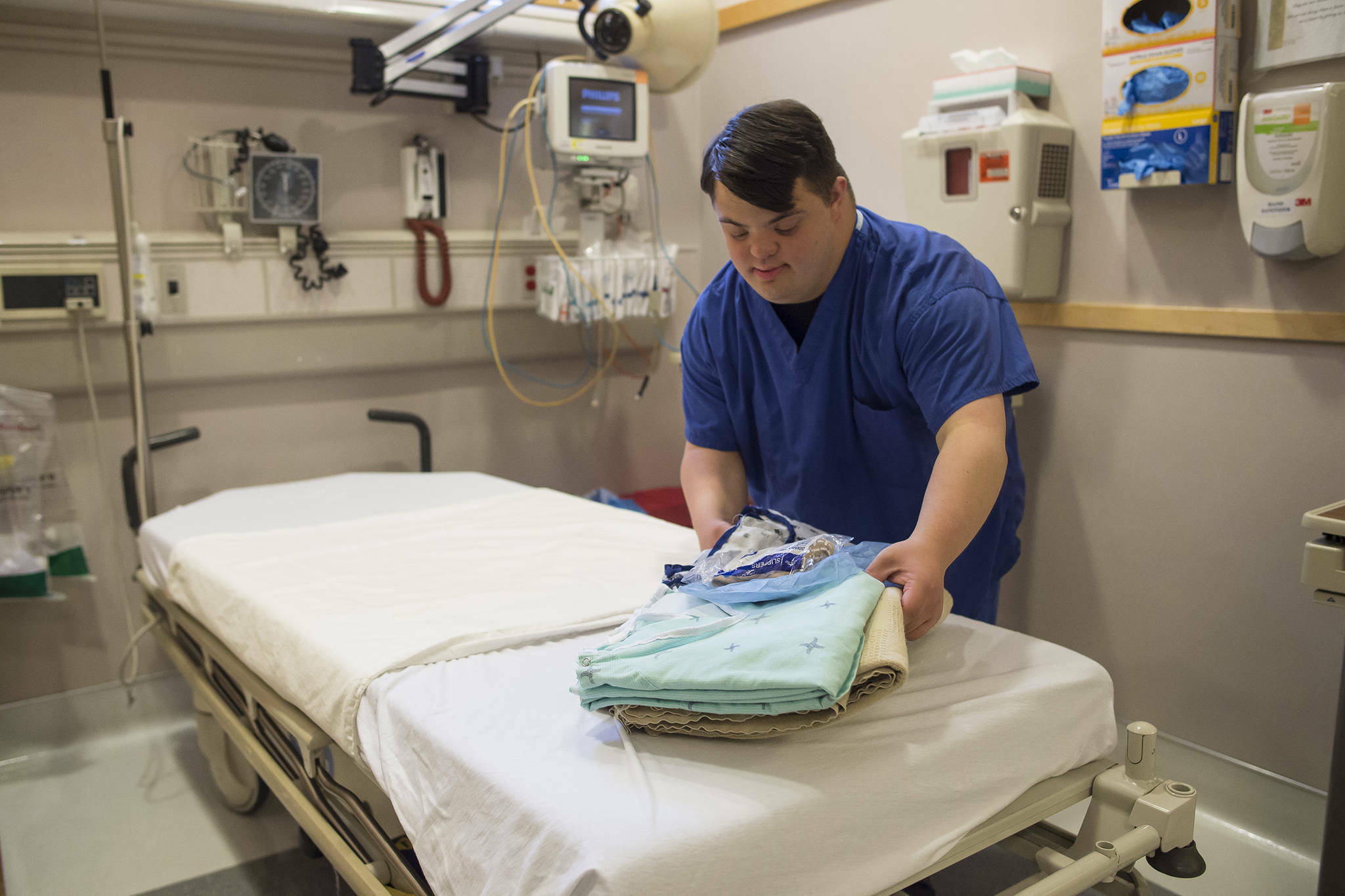 Solomon Dunlap cleans and makes up beds in the day surgery department as part of his internship at Bartlett Regional Hospital on Friday, Oct. 5, 2018. (Michael Penn / Juneau Empire file photo)