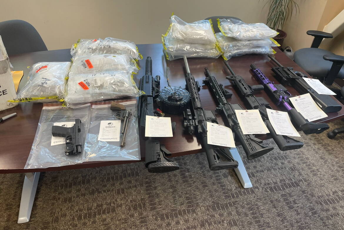 Firearms and counterfeit oxycodone pills containing fentanyl seized by law enforcement agents in Alaska are shown in this undated photo. The volume of drugs seized this year at Anchorage's airport was nearly twice that seized last year. (Photo provided by the Alaska State Troopers)