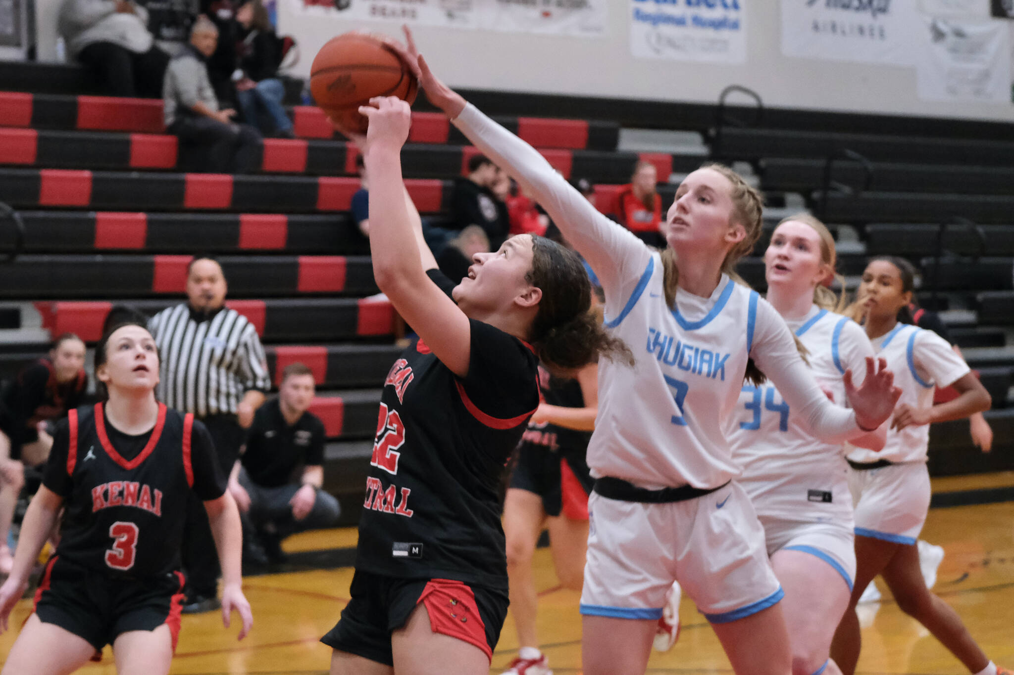 Chugiak freshman Kaitlyn Farr (3) checks Kenai freshman Bryleigh Williams (22) during the Mustangs 43-34 win over the Cardinals in the opening game of the George Houston Capital City Classic Friday in Juneau. (Klas Stolpe / Juneau Empire)