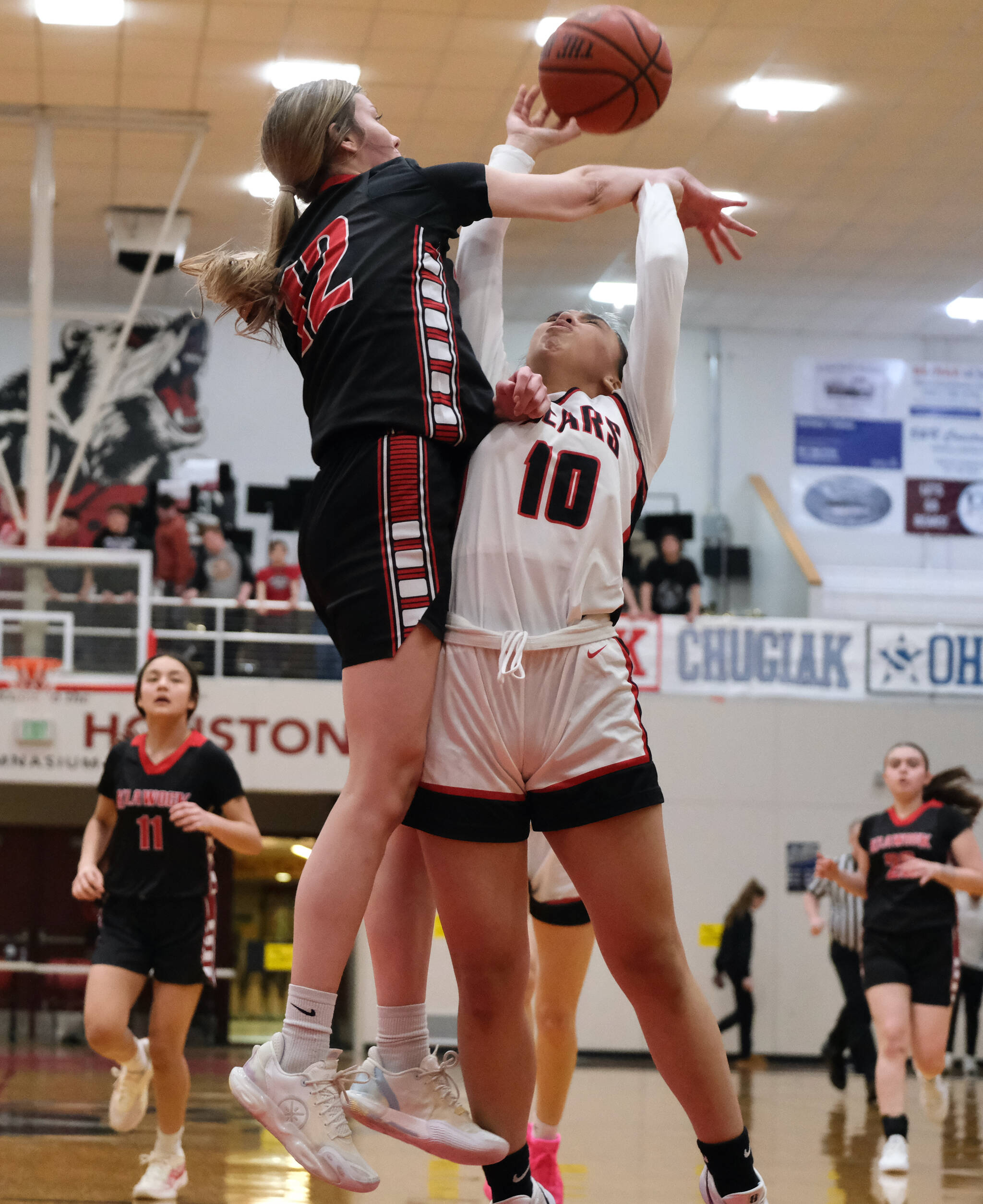 Juneau-Douglas High School: Yadaa.at Kalé Crimson Bears senior Addison Wilson (10) is fouled by Klawock senior Kaiya Marvin during the Crimson Bears 71-21 win over the Chieftains on the opening day of the George Houston Capital City Classic on Friday in Juneau. (Klas Stolpe / Juneau Empire)