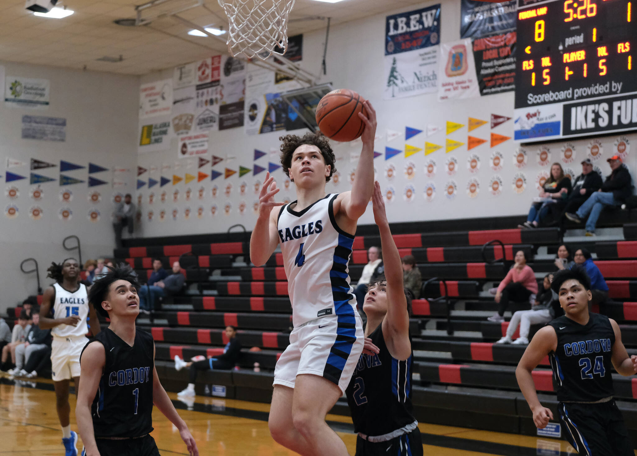 Federal Way senior Brayden McVey (4) scores past Cordova senior John Itliong (1) and junior Blake Bailey (2) in the Eagles 64-31 win over the Wolverines during Saturday action at the George Houston Capital City Classic in Juneau. (Klas Stolpe / Juneau Empire)