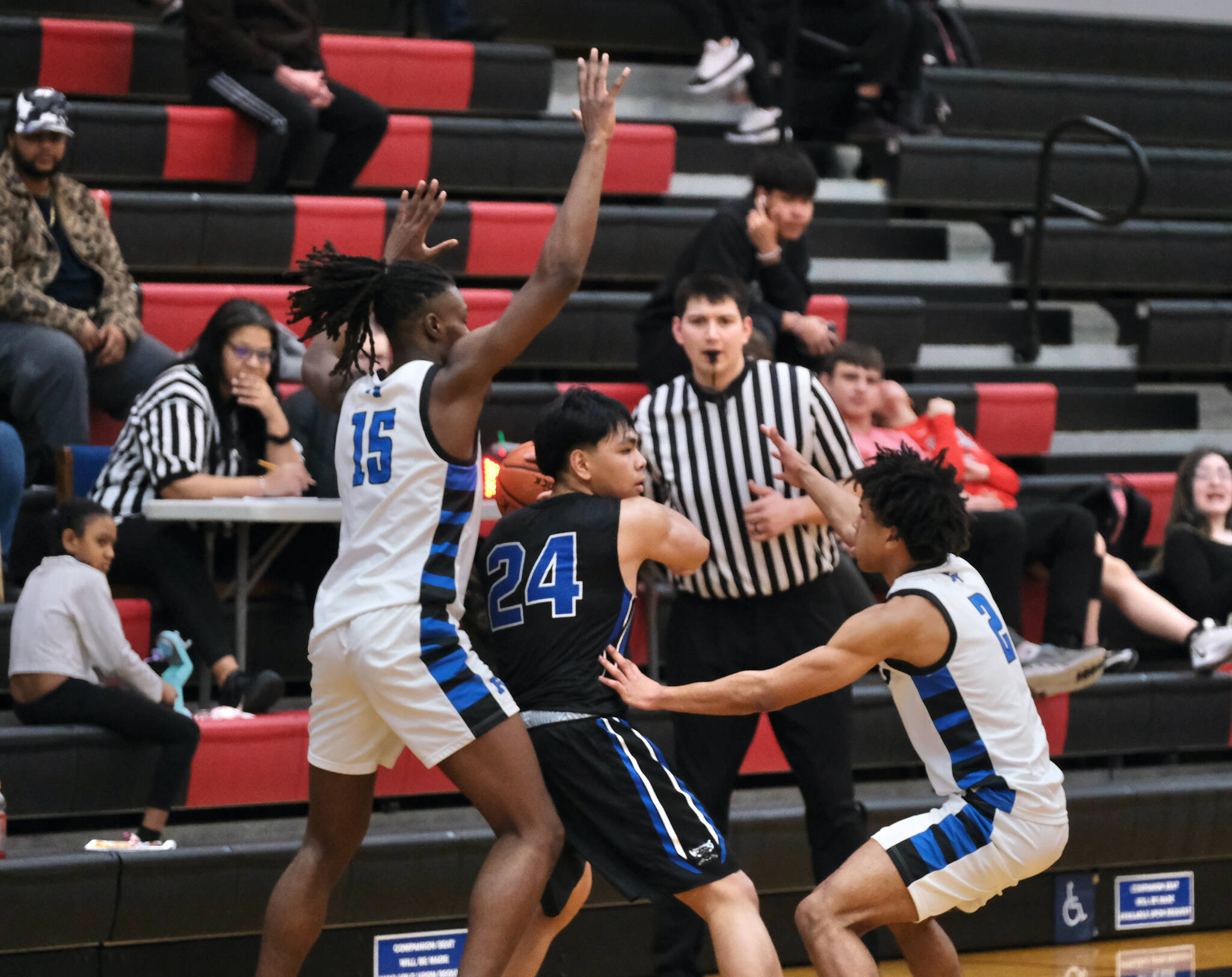 Federal Way senior Saxon Niles (15) and senior Angelo Williams (2) trap Cordova senior Chiko Jacob (24) in the Eagles 64-31 win over the Wolverines during Saturday action at the George Houston Capital City Classic in Juneau. (Klas Stolpe / Juneau Empire)